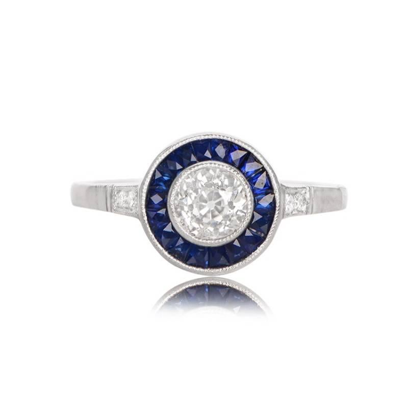 This stunning Art Deco-style ring boasts a 0.50-carat antique old European cut diamond, with a J color grade and VS2 clarity. It's beautifully accented by a row of French-cut calibre natural sapphires encircling the center diamond. Old European cut