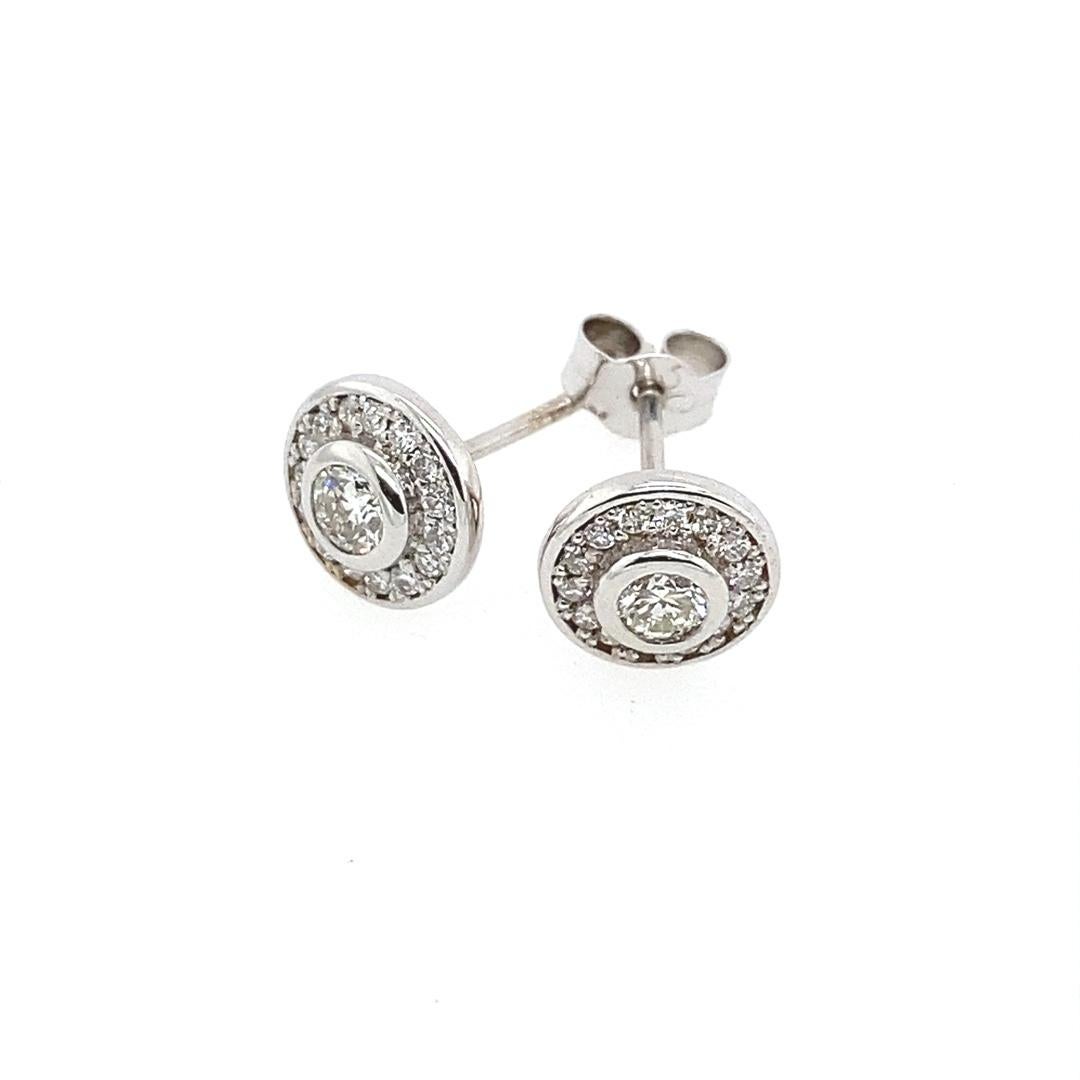 18ct White Gold Halo Stud Earrings set with 0.50ct of Diamonds

The earrings are a halo style design with a Round Brilliant Cut Diamond in the centre. The earrings sparkle with a brilliant shine and have a total diamond weight of 0.50ct, they are a