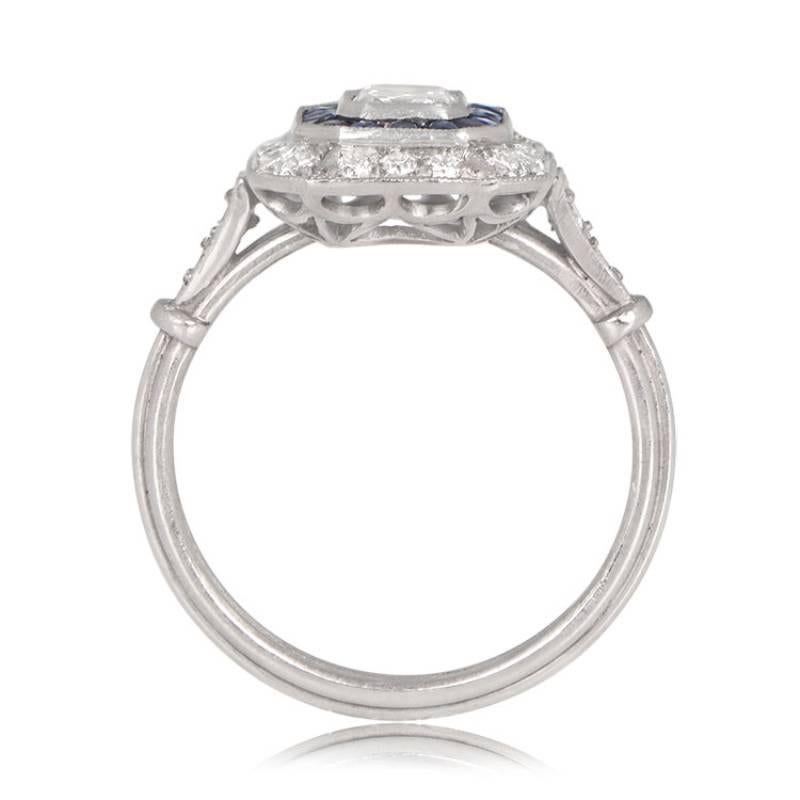 An exquisite double halo ring showcasing a lively 0.50 carat emerald cut diamond at its center. The diamond is enveloped by a double halo of French-cut sapphires and diamonds, creating a captivating contrast. Meticulously handcrafted in platinum,