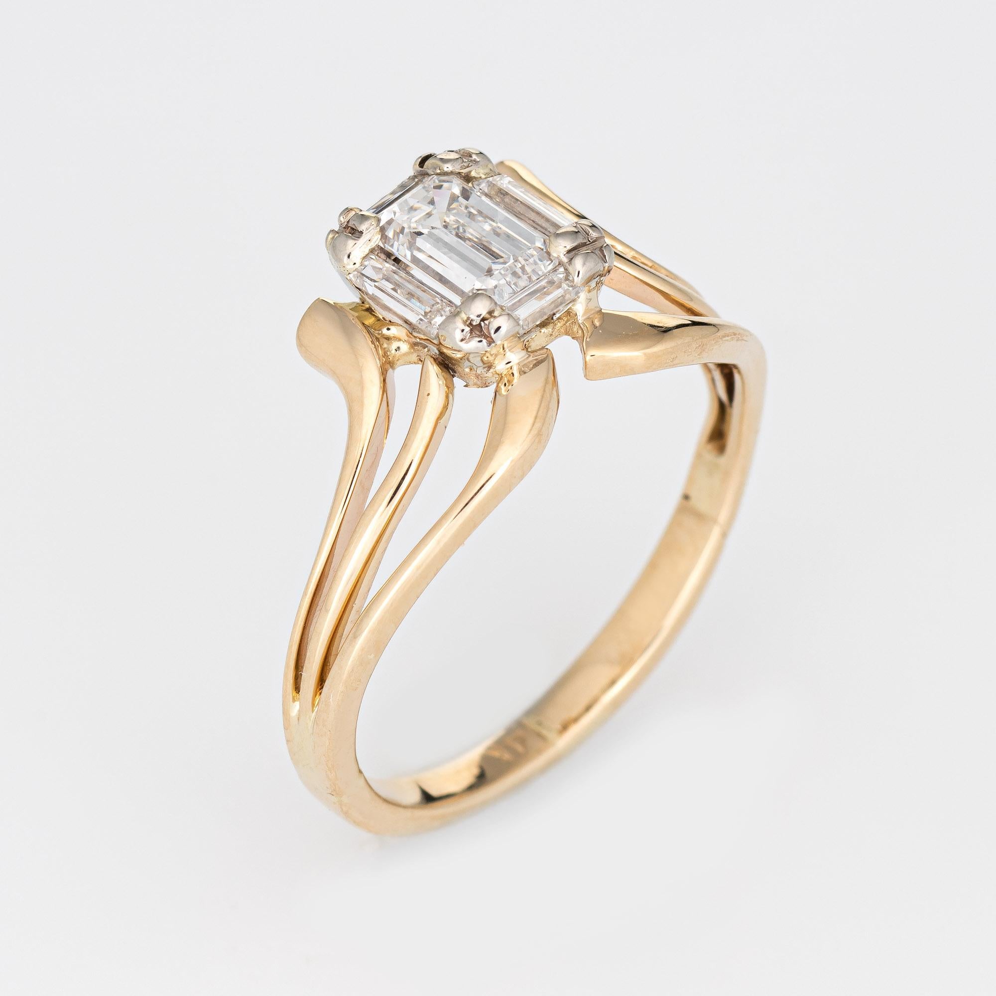 Stylish vintage emerald cut diamonds ring (circa 1960s) crafted in 14 karat yellow gold. 

Centrally mounted estimated 0.50 carat emerald cut diamond is accented with four estimated 0.20 carat straight baguette cut diamonds. The total diamond weight
