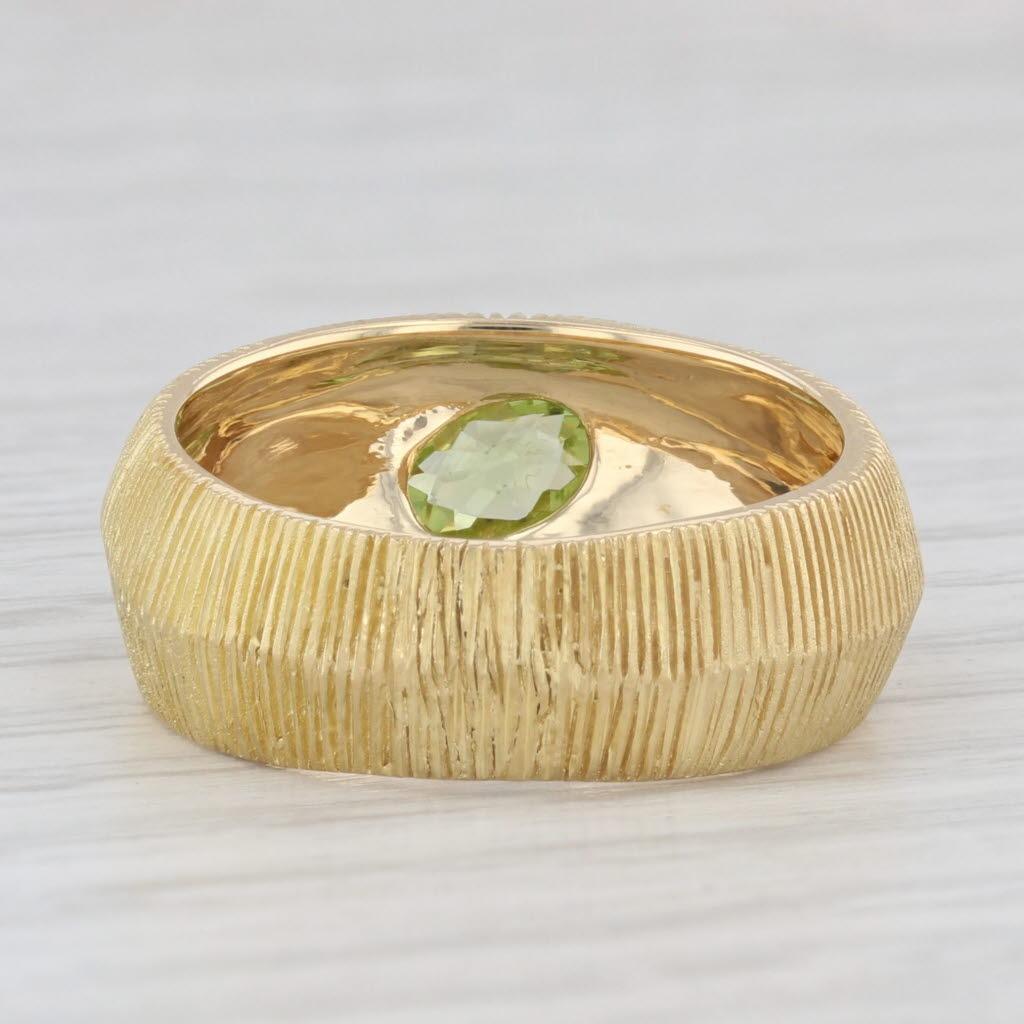 Gemstone Information:
- Natural Peridot -
Carats - 0.50ct 
Cut - Oval Brilliant
Color - Light Green

Metal: 18k Yellow Gold 
Weight: 9.1 Grams 
Stamps: 18k
Face Height: 9 mm 
Rise Above Finger: 4.2 mm
Band / Shank Width: 6.9 mm

This ring is a size