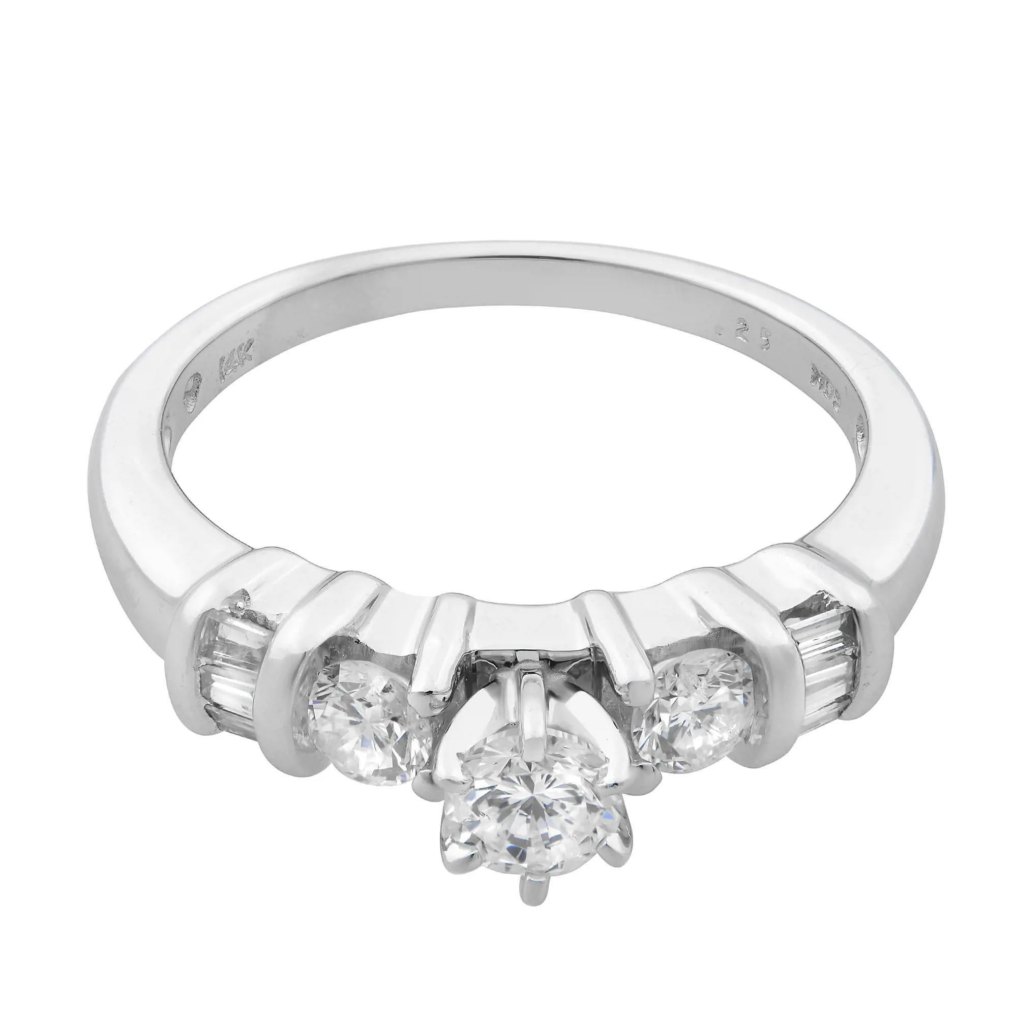 This beautiful ladies engagement ring is crafted in 14k white gold. It features a center prong set round brilliant cut diamond with baguette and round cut diamonds on each side. Total diamond weight: 0.50 carat. Diamond quality: G-H color and VS-SI