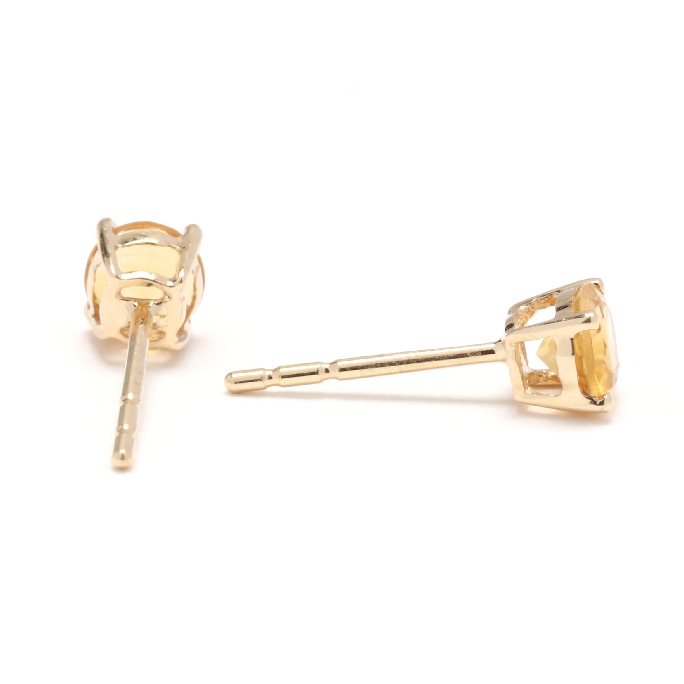 A pair of vintage 14 karat yellow gold round citrine solitaire stud earrings. These November birthstone earrings feature prong set, round cut citrines weighing approximately .50 total carat and with pierced push backs.

Stones:
- citrine, 2 stones
-