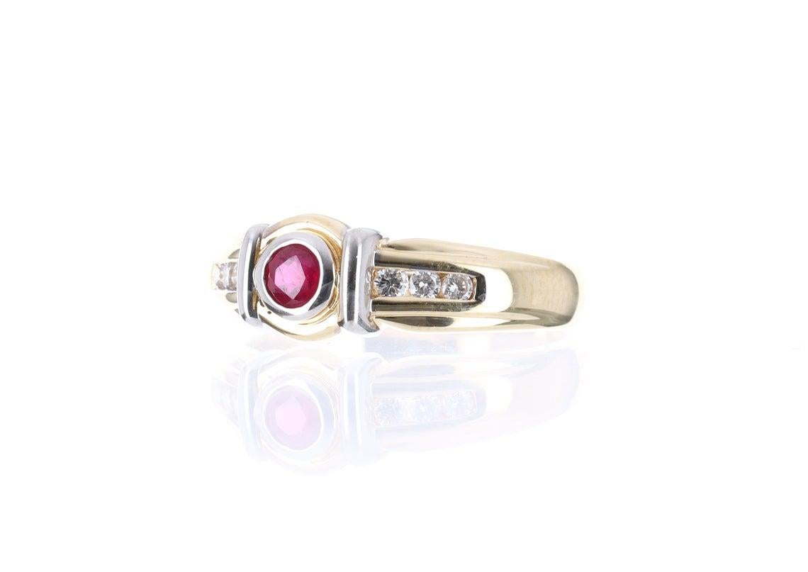 Displayed is a romantic 0.50-carat natural ruby and diamond solitaire ring in solid gold. Created in solid 14 karat gold, this ring features a beautiful ruby in its center. Bezel set in a thin layer of white gold the ruby is tightly secured, the