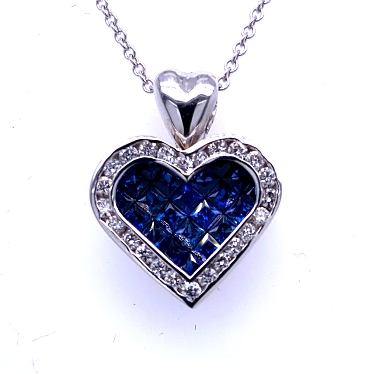 18K Gold Heart shaped Pendant with 21 Invisible Set Princess Cut Blue Sapphires (Total Gem Weight 1.47 Ct) surrounded by a Channel set Halo of diamonds with total weight of 0.51 Ct. 
Total Diamond Weight: 0.51 Ct
Total Gem Weight: 1.47 Ct
Total