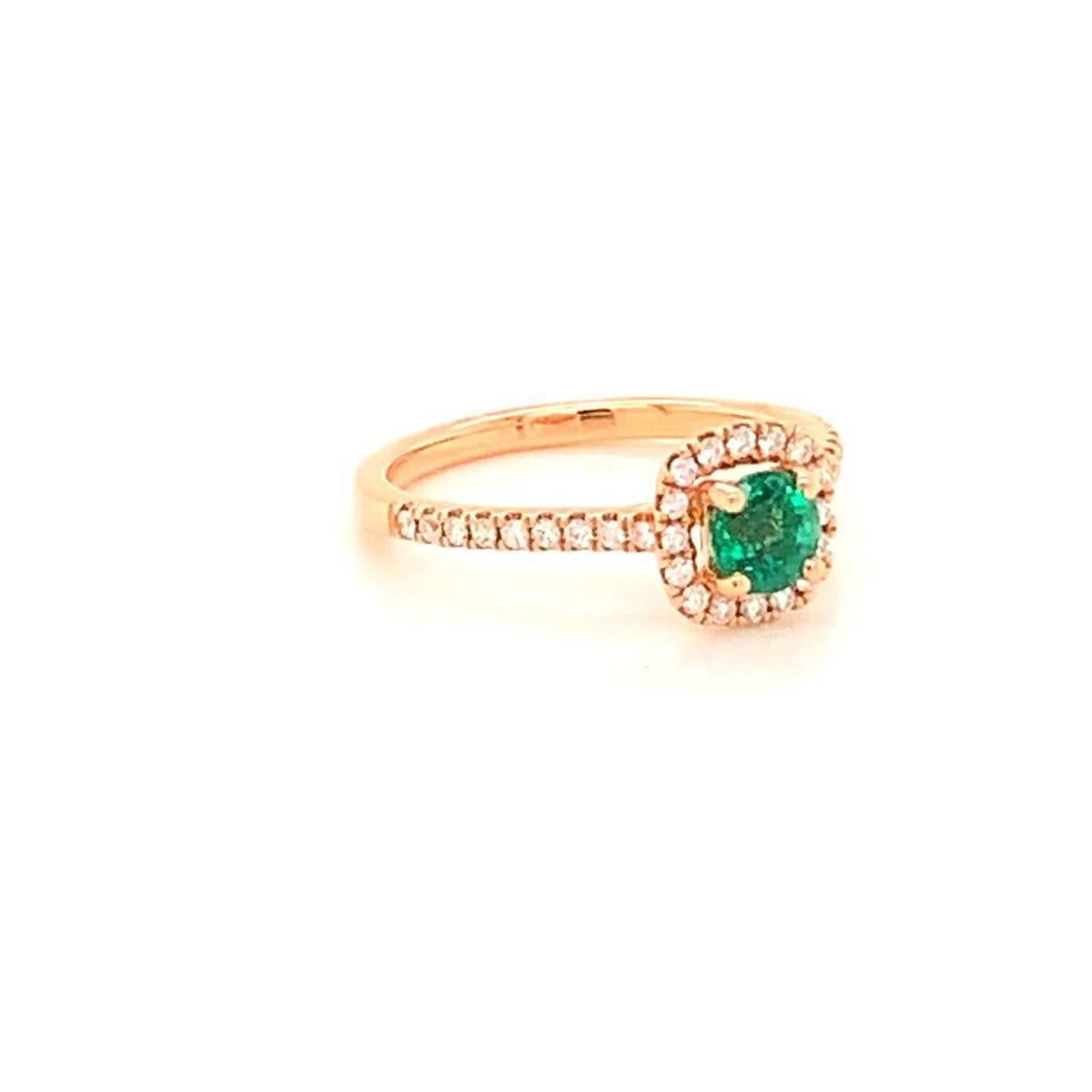 This beautifully elegant ring is made of a delightful Round Brilliant Columbian Emerald surrounded by a glimmering halo of scintillating Round Brilliant Diamonds set in a Diamond encrusted band made of 18K Rose Gold. The Emerald in this gorgeous