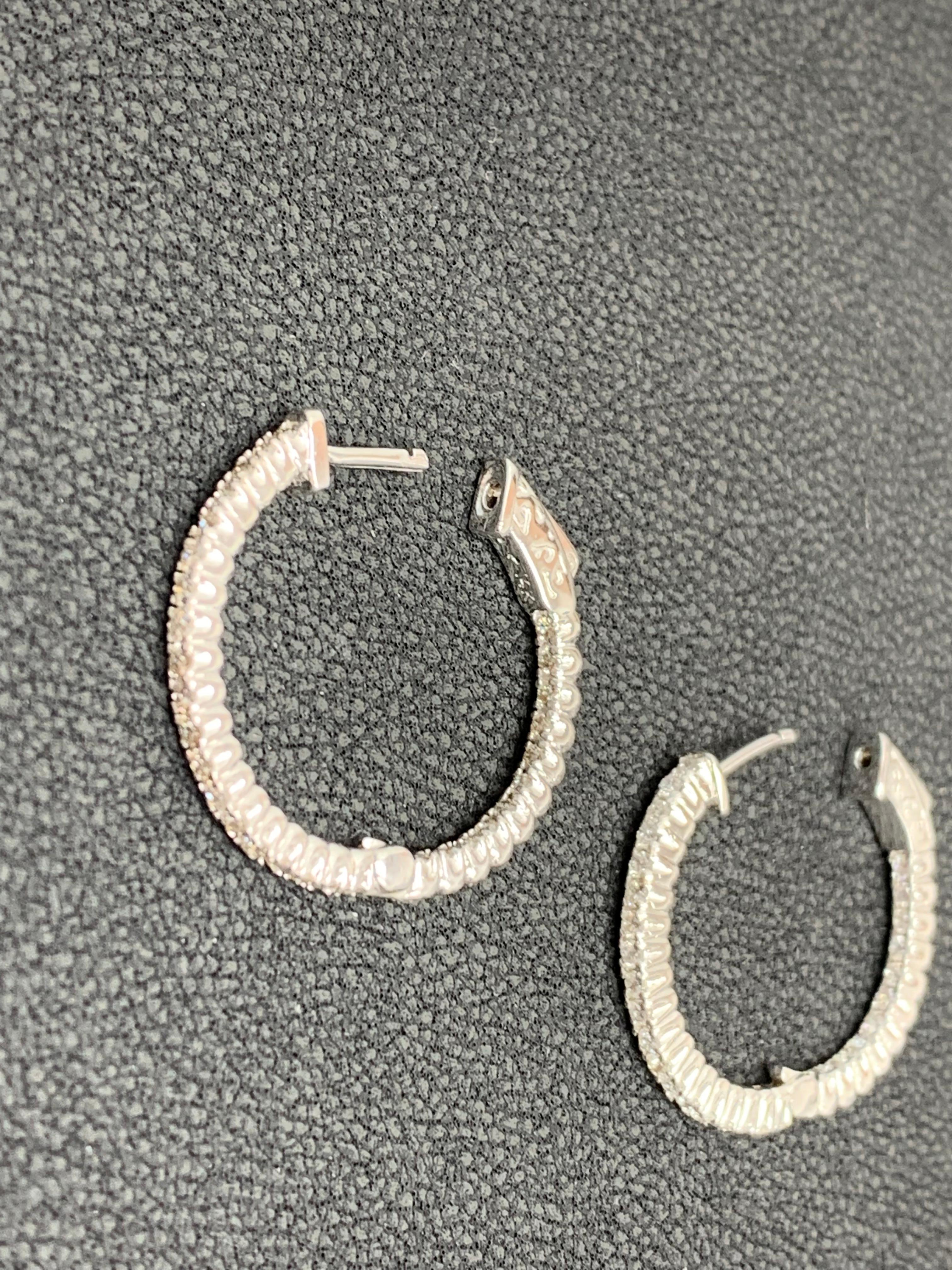 A chic and fashionable pair of hoop earrings showcasing brilliant-cut round diamonds, set in 14k white gold.  30 Round diamonds weigh 0.51 carats in total. A beautiful piece of jewelry.
All diamonds are GH color SI1 Clarity.
Style is available in