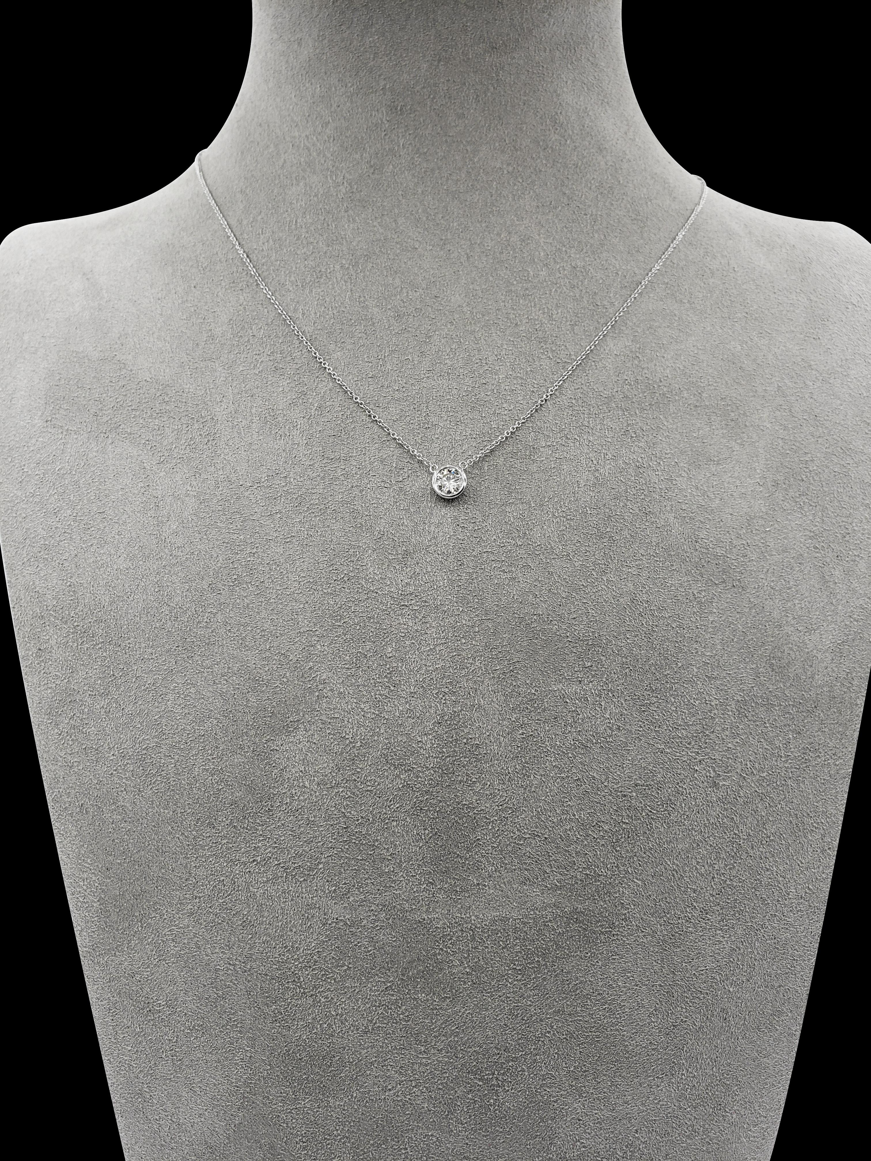 A simple and versatile solitaire pendant necklace showcasing a single round diamond in a 14 karat white gold bezel. Diamond weigh 0.51 carats. Attached to a 16 inch white gold chain (Adjustable upon request).

Roman Malakov is a custom house,