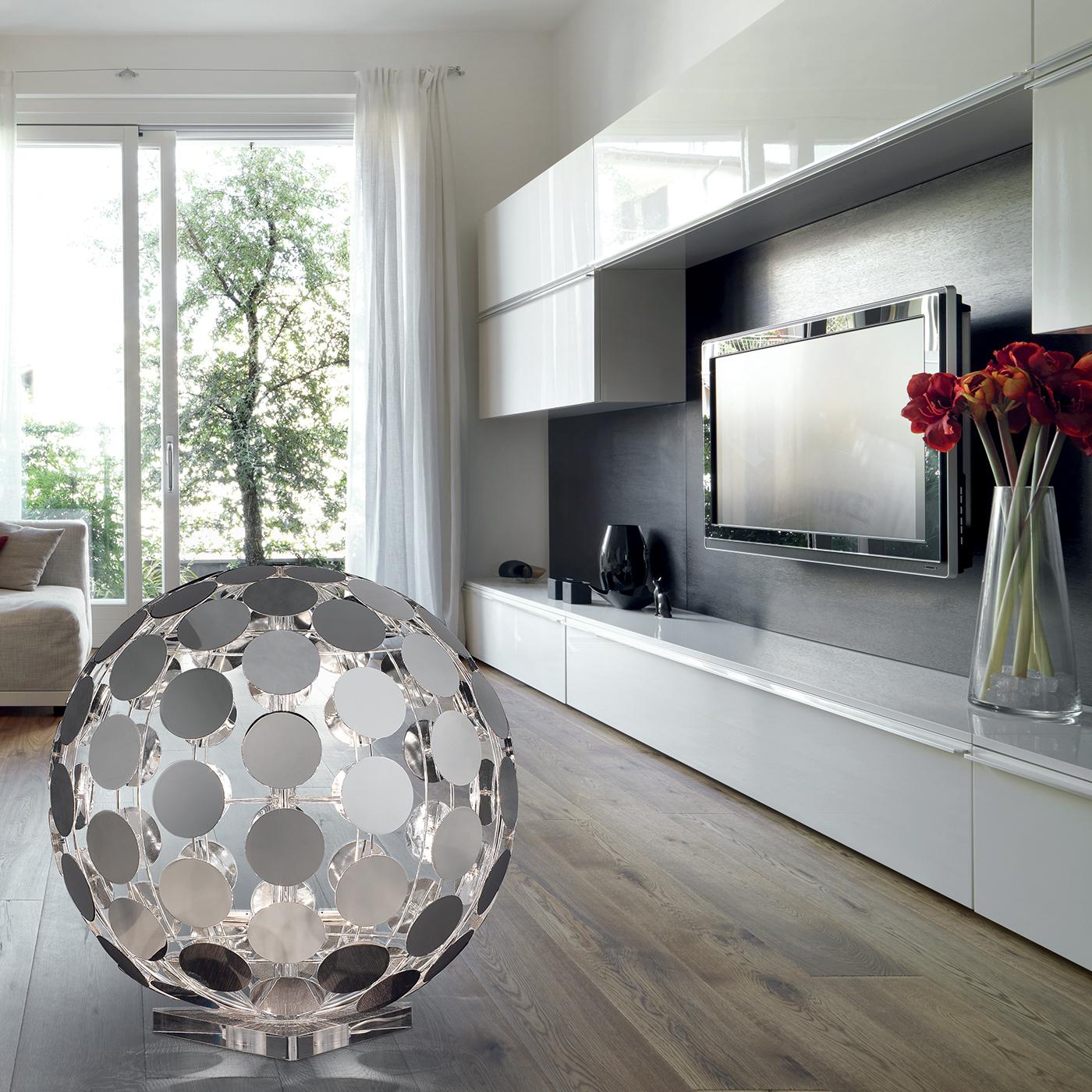 Add a glamorous touch to any living space with this unique floor lamp. Crafted from individual chrome disks arranged into a sleek spherical shape, the disco ball floor lamp reflects the light across the room in a dazzling display of light effects.