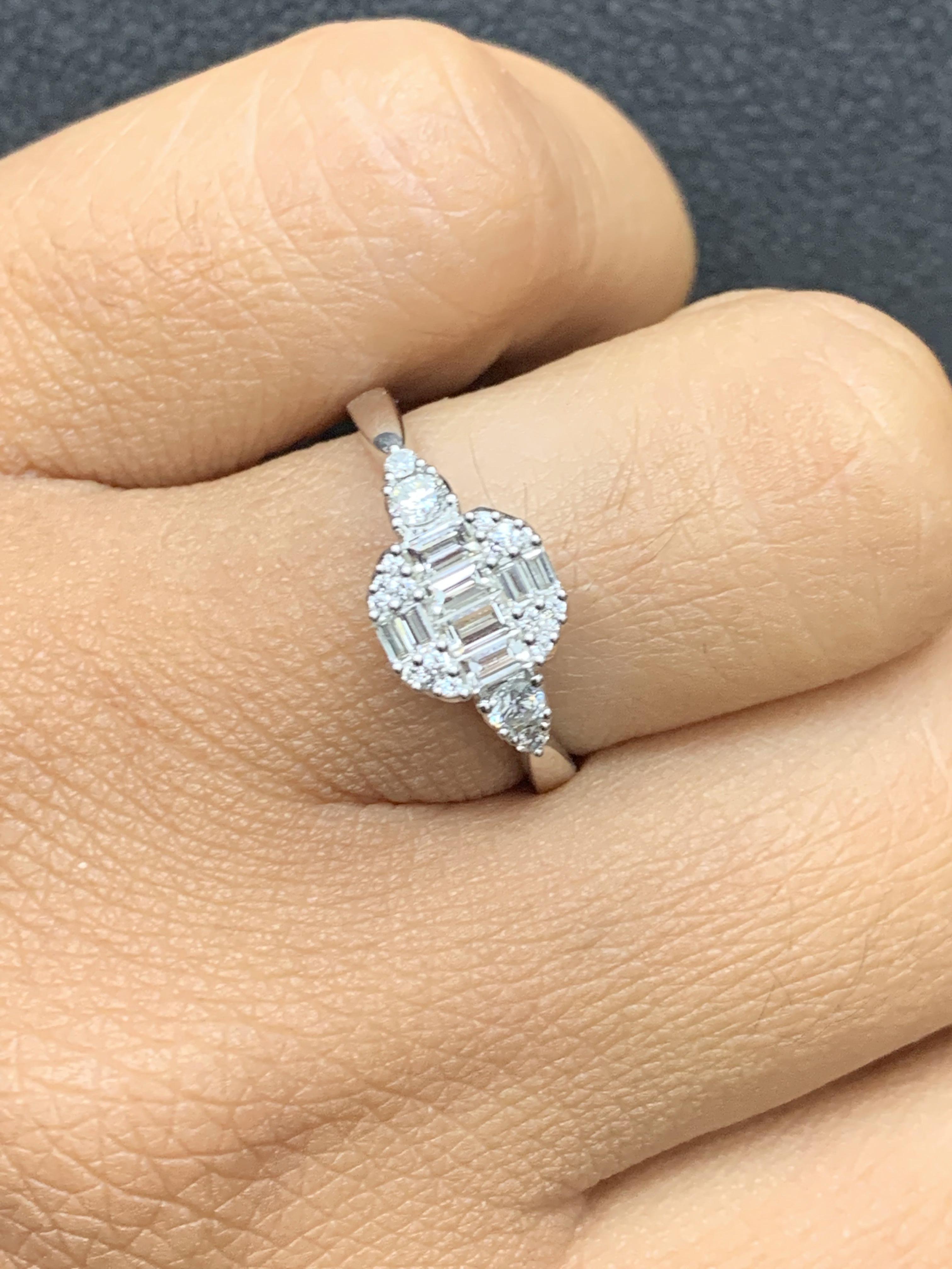 A brilliant and unique piece featuring a cluster of baguettes and round diamonds shaped like an emerald cut. 8 Baguette diamonds in the center weigh 0.32 carats total; Accent round diamonds weigh 0.20 carats total. Made in 18k white gold. Size 6.5