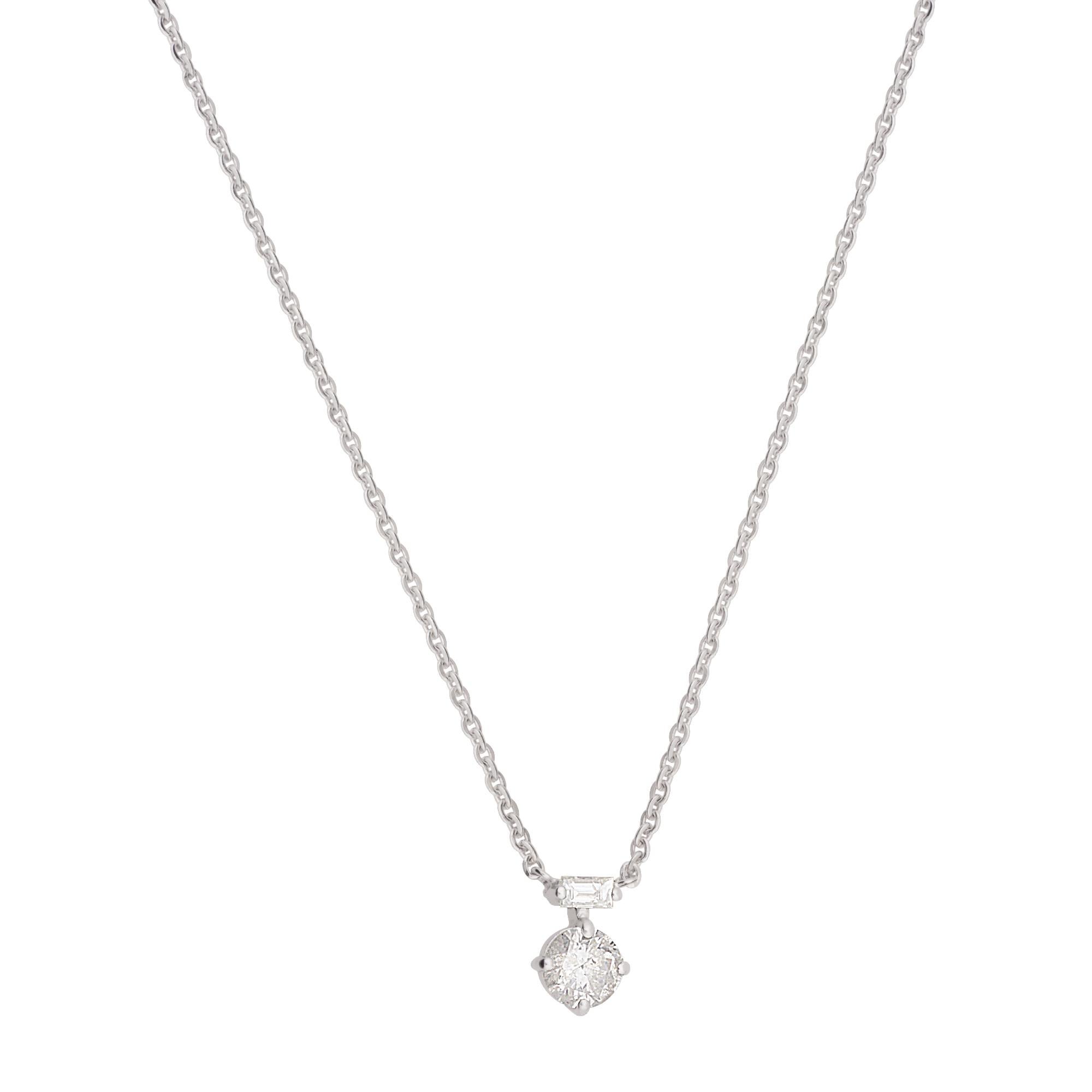 The charm pendant delicately hangs from a solid 14k white gold chain, creating a seamless and harmonious look. The chain's refined and elegant design adds a touch of sophistication to the necklace, making it suitable for both formal occasions and