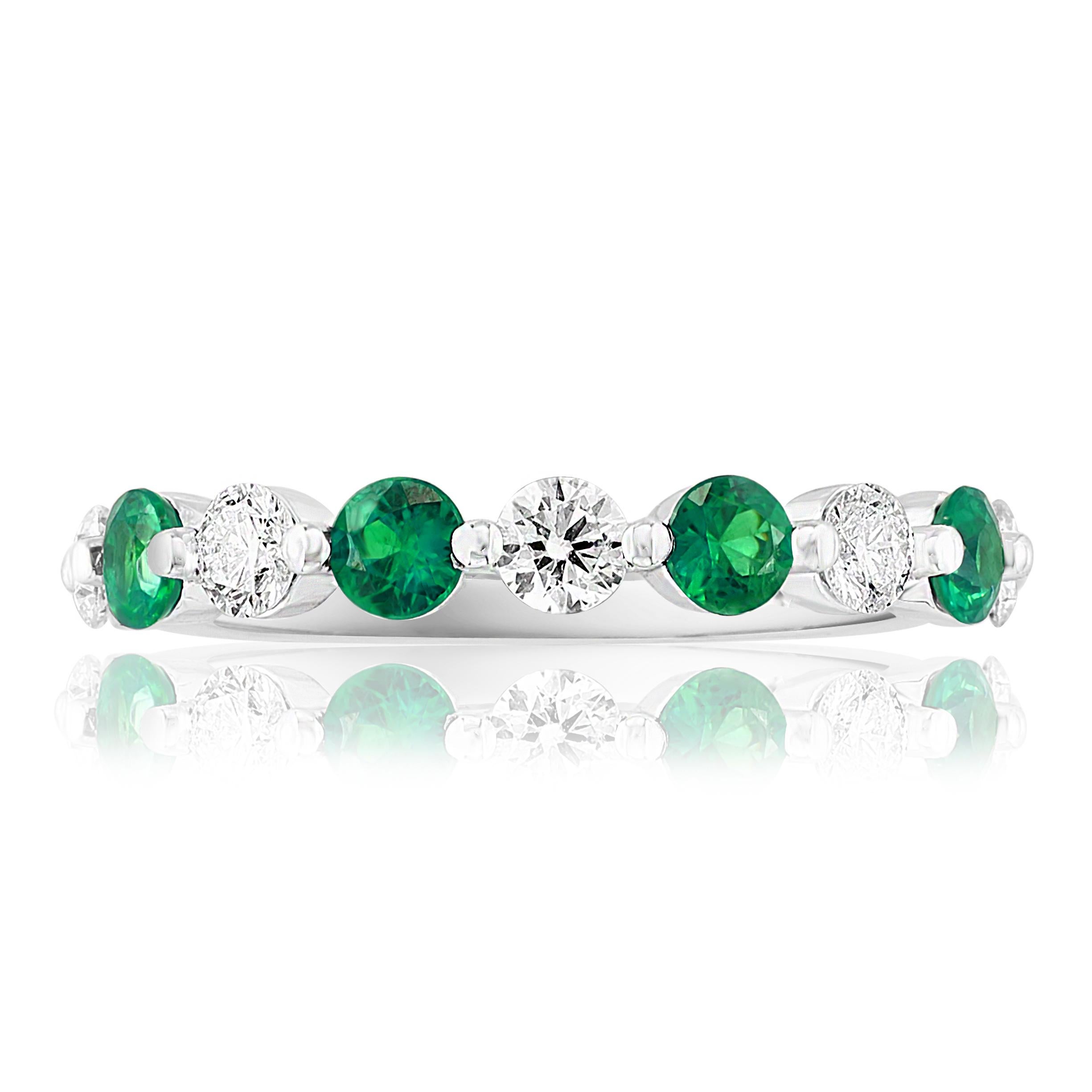 A fashionable and classic wedding band showcasing 5 brilliant cut diamonds weighing 0.50 carats total alternating with 4 round emeralds weighing 0.52 carats. Stones secured with a shared prong setting made with 14K white gold. A versatile piece that