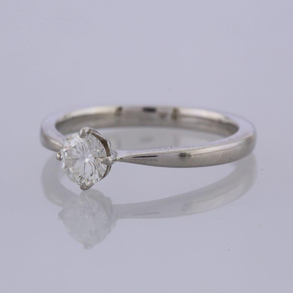 This is a platinum round brilliant cut diamond solitaire engagement ring.

Condition: Used (Excellent)
Weight: 4.9 grams
Size: P
Diamond Details: 0.52 Carats, Colour: G, Clarity: VS1
Hallmarked: Yes
Date Of Manufacture: Modern
Box: The Vintage