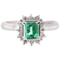 0.52 Carat Natural Emerald and Diamond Halo Ring Set in Platinum
