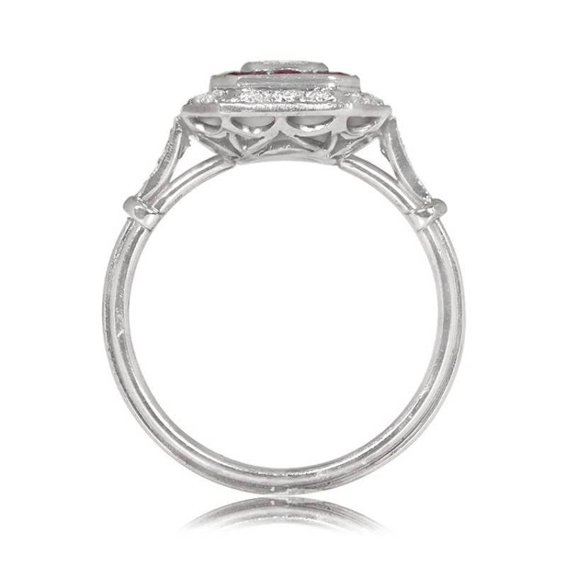 A captivating ring featuring a 0.52-carat emerald-cut diamond at its center, encircled by dual halos of diamonds and rubies. Additional diamonds grace the shoulders of the ring. The center diamond, with a weight of about 0.52 carats, boasts J color