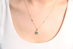 0.53 Carat Oval Cut Emerald Diamond Accents 10K Yellow Gold Pendant