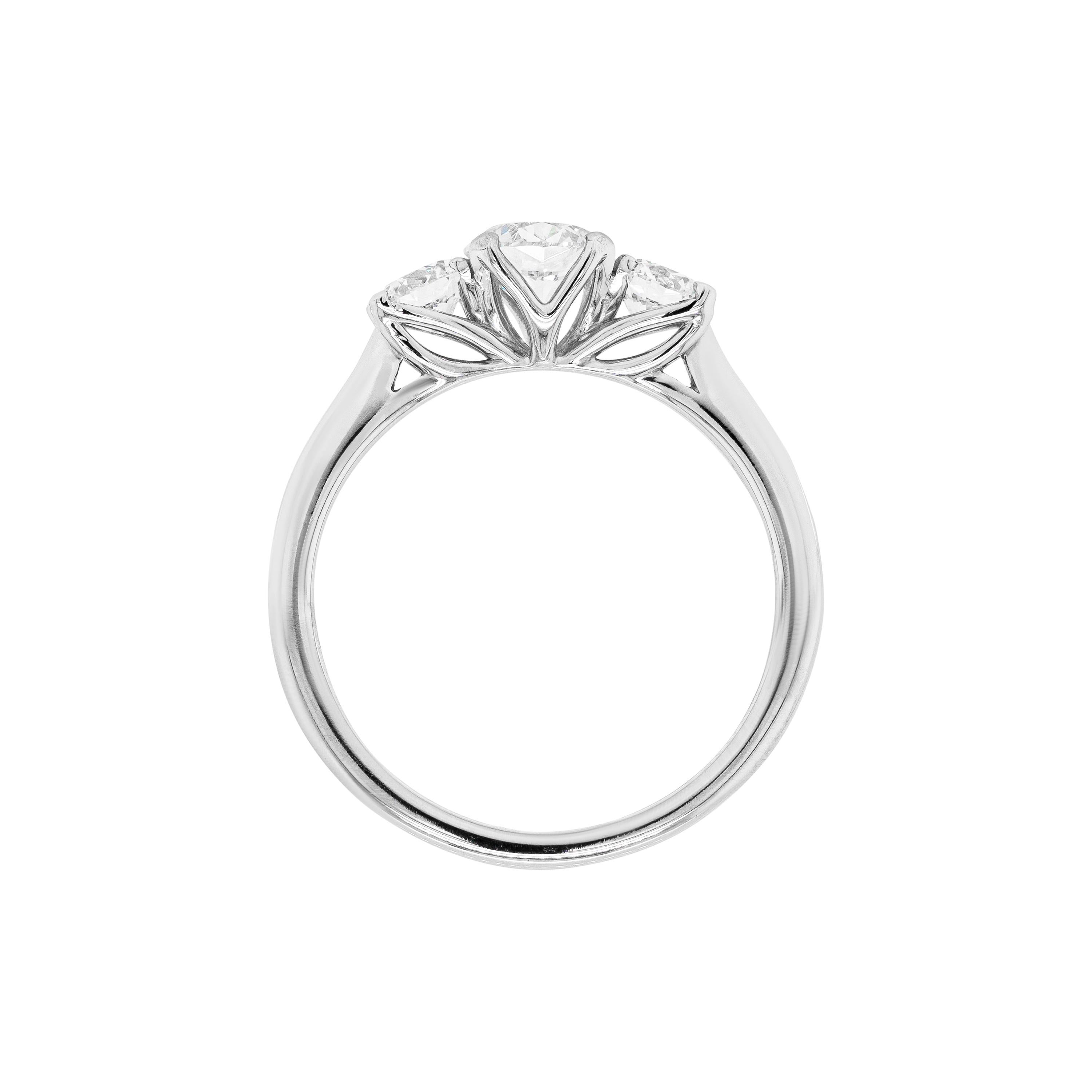This gorgeous three-stone engagement ring features a trio of round brilliant cut diamonds, the centre stone weighing 0.53ct, certified E in colour and VS1 in clarity, and the side ones 0.46ct combined. All three stones are claw set to an open-work