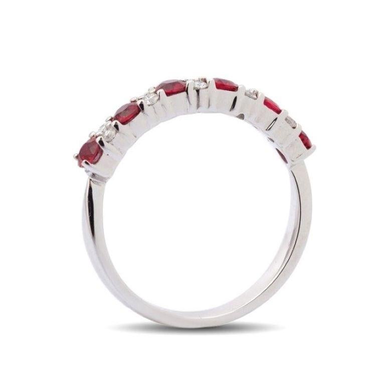 Set with 0.54 carats of deep red round brilliant Rubies, this ring will steal her heart. Made with love by artisans in 14K white gold, it has 0.11 carats of diamonds that have been evenly set between each ruby. Like a wreath of flowers, this ring