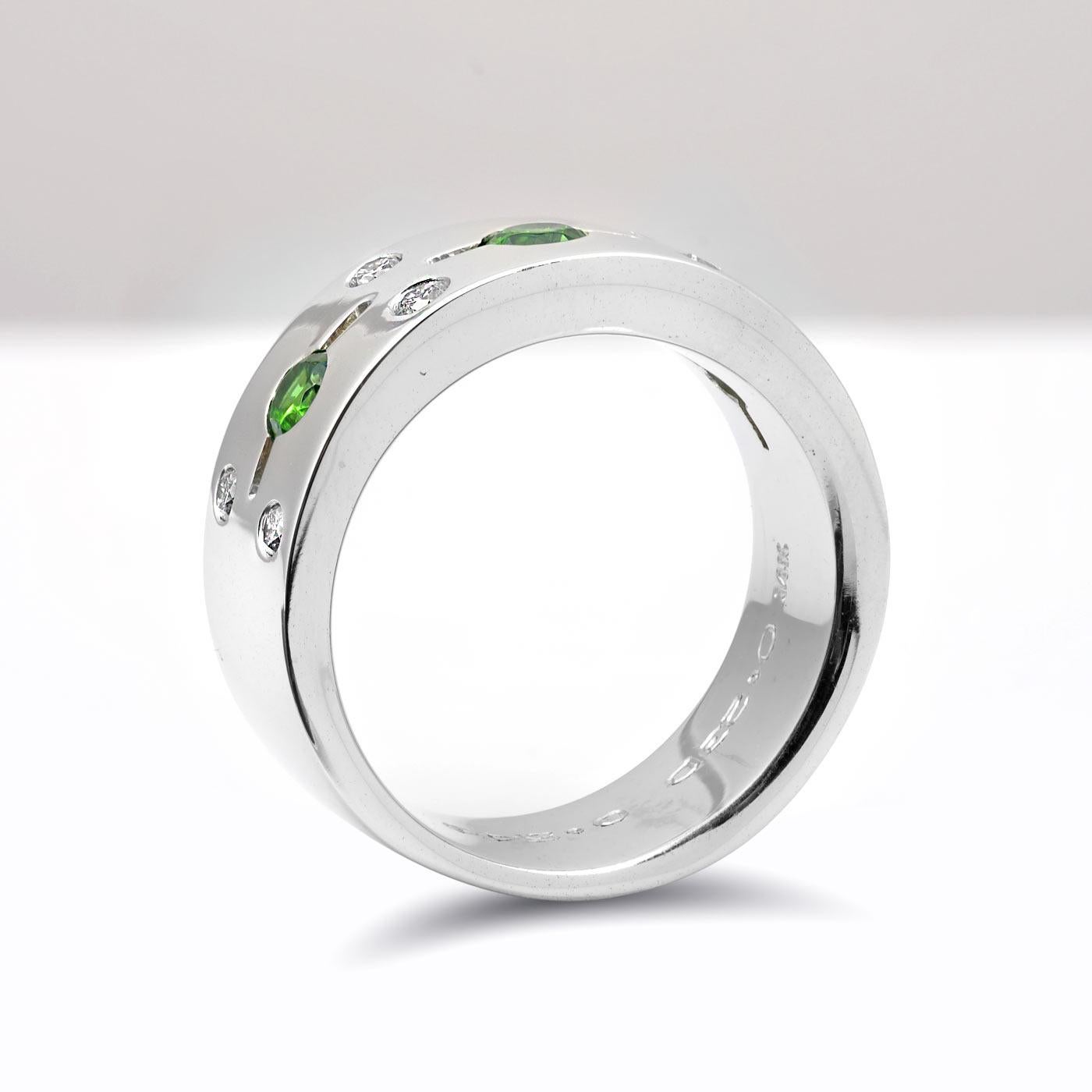 Studded with 3 Russian mined Demantoid garnets, this 14K white gold ring is an absolute beauty. Each filled with a vibrant green these garnets unlike emeralds have exceptional hardness and can withstand a lot of daily wear and tear. Cut to