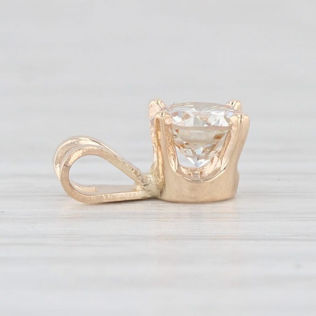Gemstone Information:
- Natural Diamond -
Carats - 0.54ct 
Cut - Round Brilliant
Color - Light Brown
Clarity - SI2 - I1

Metal: 14k Yellow Gold
Weight: 0.5 Grams 
Stamps: 14k
Measurements: 9.6 x 5.2 mm (including bail)
The bail will accommodate up