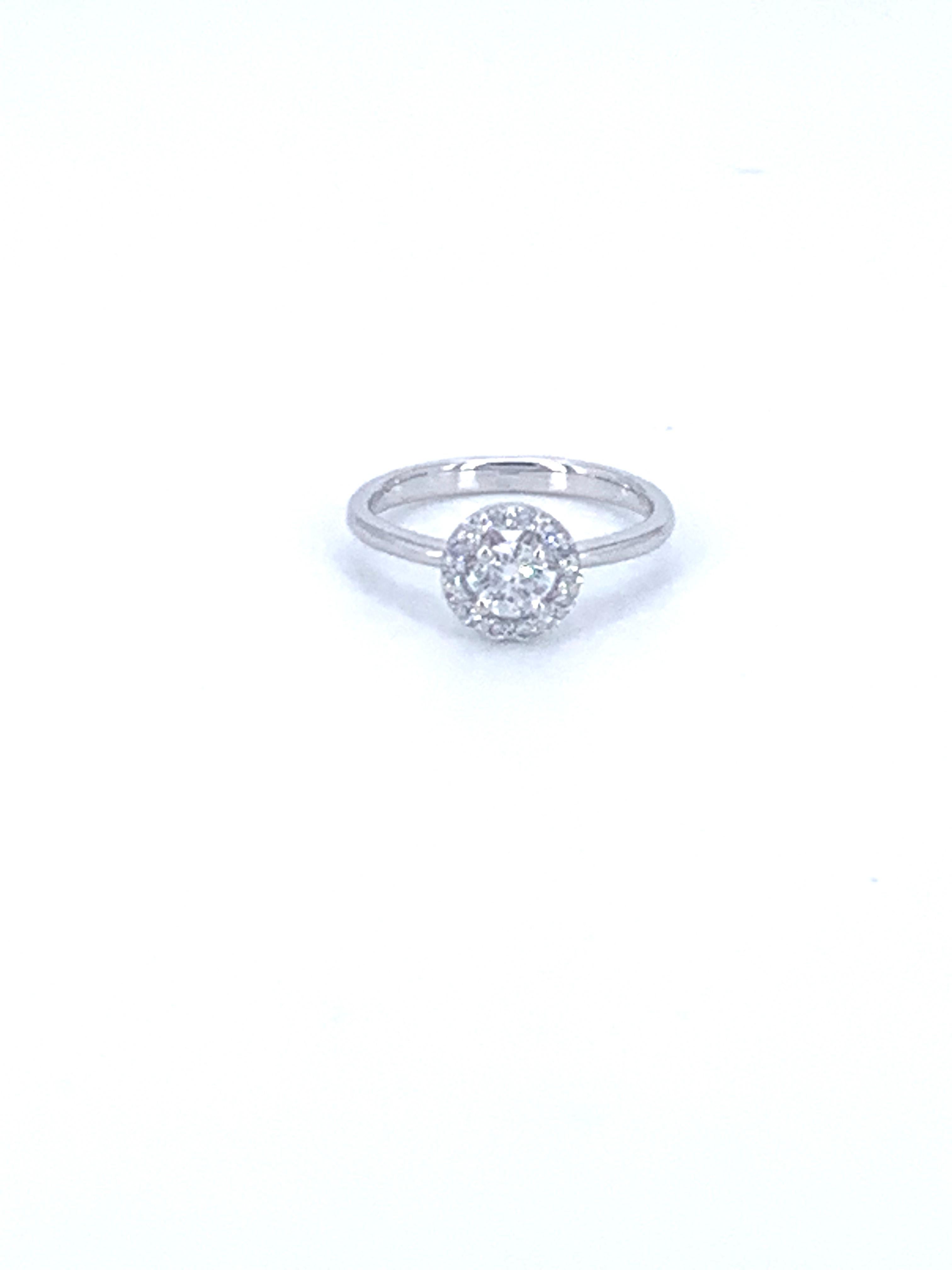 This 0.55 Carat halo solitaire diamond ring is from the Jennifer Collection and 100% made in Italy from non conflict diamonds. 
 
Set in 18Kt white Gold, the ring radiates brightness and beauty from the finger.

Crafted so the centre diamond is the
