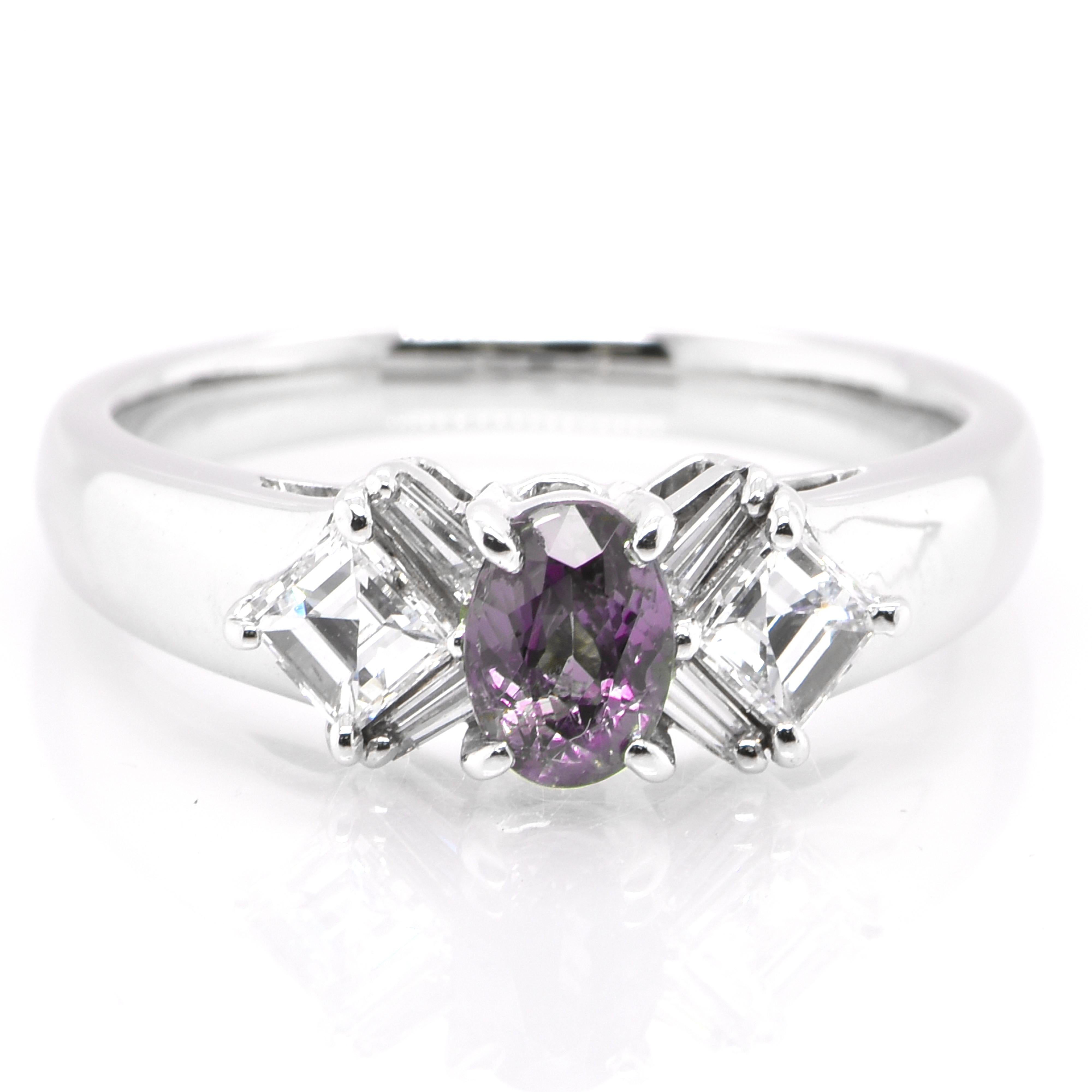 A gorgeous ring featuring a 0.55 Carat, Natural Alexandrite and 0.49 Carats of Diamond Accents set in Platinum. Alexandrites produce a natural color-change phenomenon as they exhibit a Bluish Green Color under Fluorescent Light whereas a Purplish