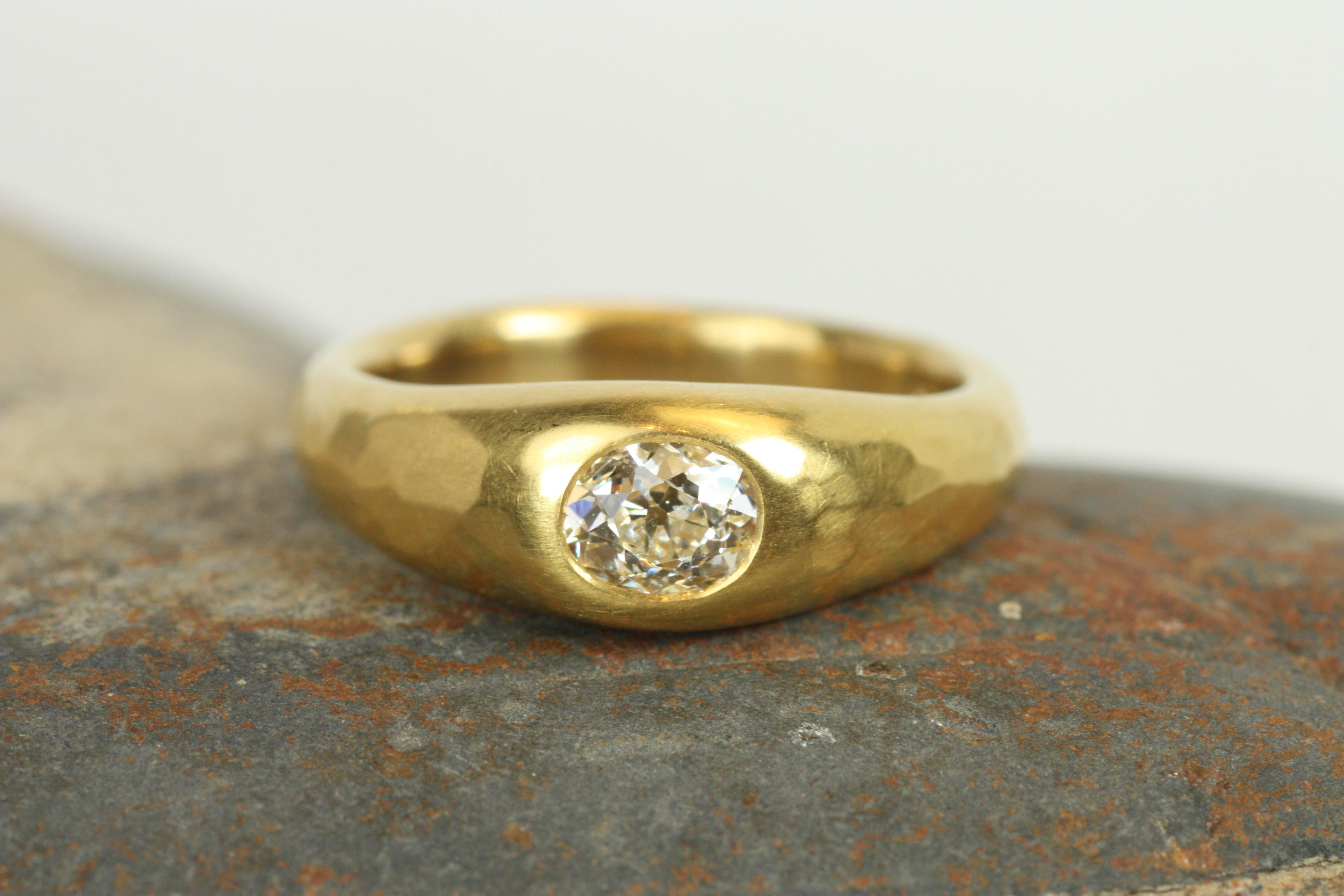 The beauty of this 0.55ct old mine cut diamond lies in its ancient charm, set in rich 22K yellow gold with a matte hammered finish. The old mine cut, with its distinct sparkle, brings a sense of history to this unique solitaire gypsy ring. Its