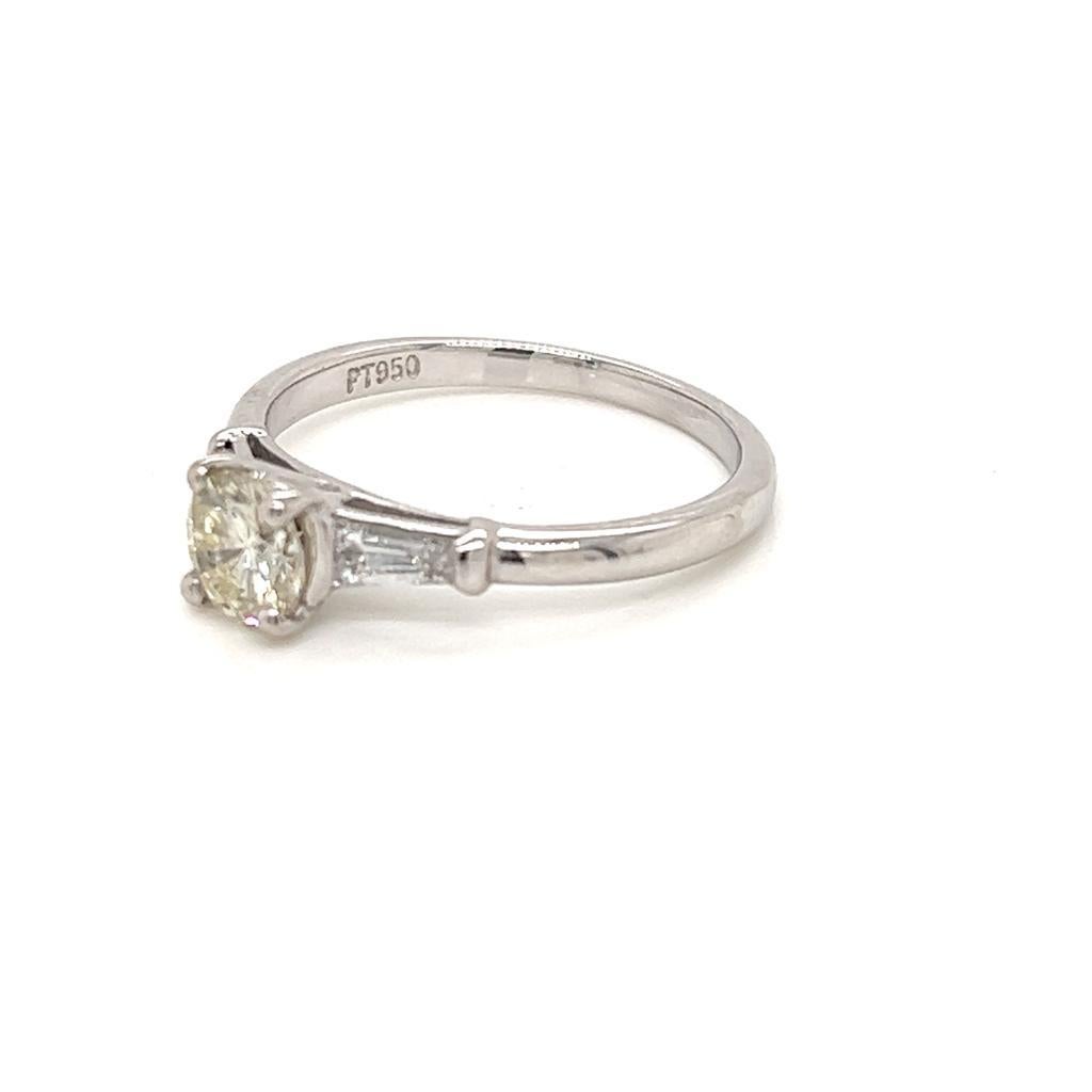 0.55 Carat Round Brilliant Diamond with Tapered Side Diamonds Platinum Ring

This glamorous three-stone ring features a marvellous 0.55 carat round brilliant Diamond at its centre. This jewel is held in a claw setting on a Platinum ring, and is of I