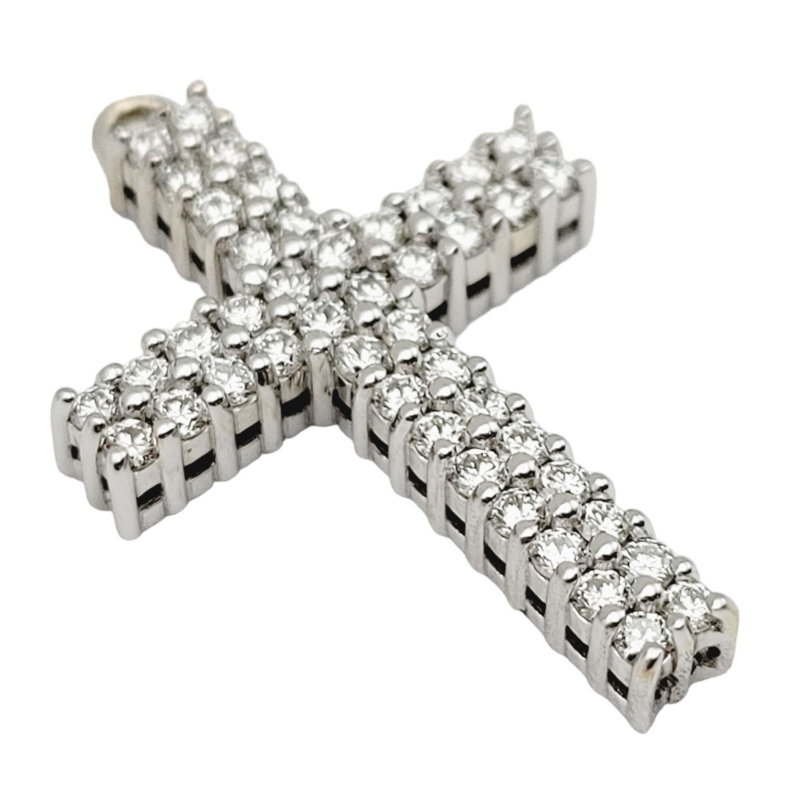 Gorgeous white gold diamond cross pendant. The cross is embellished with 0.55 carats of sparkling natural round brilliant diamonds, F-G in color and VS1-VS2 in clarity. The stunning diamonds are pave set in two rows and fill the entire cross. The