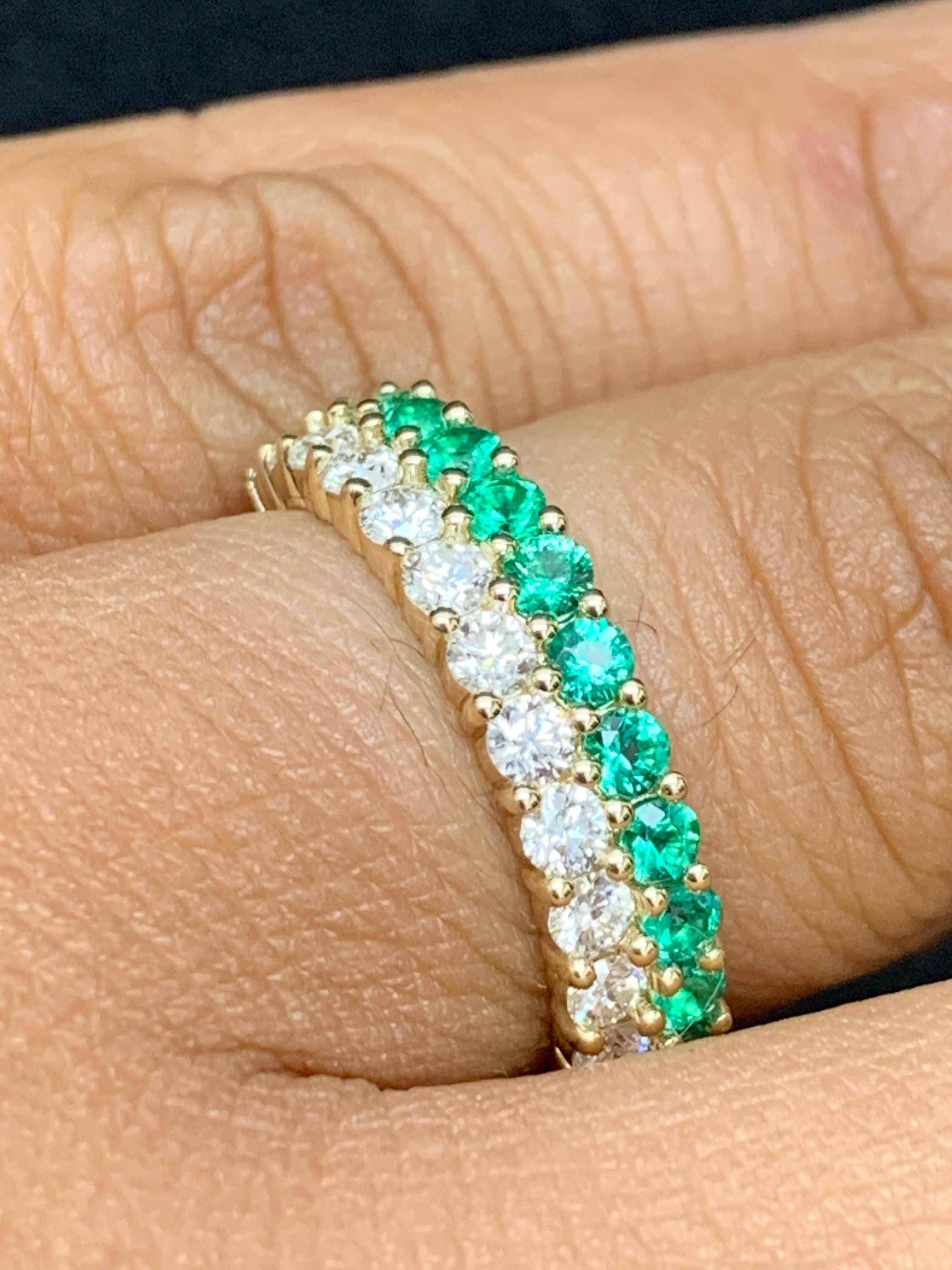 A unique and fashionable ring showcasing two rows of round-shape 13 emeralds and 14 diamonds, set in a band design. Emeralds weigh 0.55 carats and Diamonds weigh 0.70 carats total. A brilliant and masterfully-made piece.

Style available in