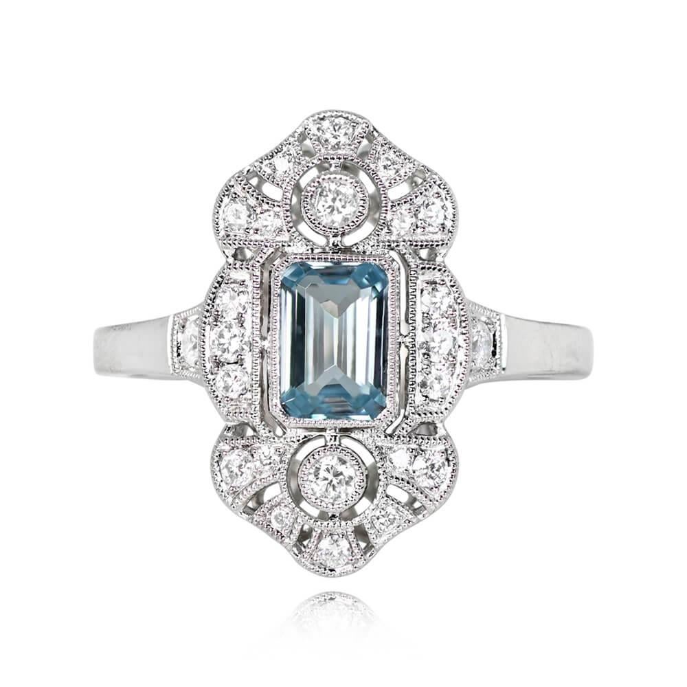 A captivating aquamarine ring with a bezel-set 0.55-carat emerald-cut aquamarine at its center. Surrounding the stone are round brilliant-cut diamonds set along the elongated platinum mounting, with an additional diamond on each shoulder. The