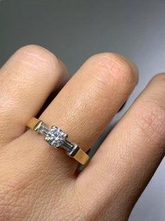 0.55ct Round and baguette diamond trilogy engagement ring in 18k yellow gold.