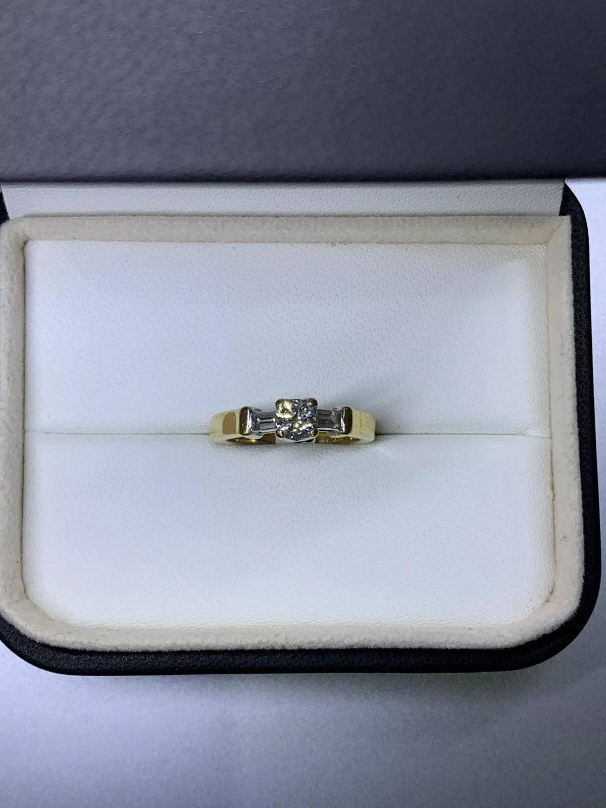 0.55ct Round and baguette diamond trilogy engagement ring in 18k yellow gold. In New Condition For Sale In London, GB