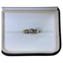 0.55ct Round and baguette diamond trilogy engagement ring in 18k yellow gold.