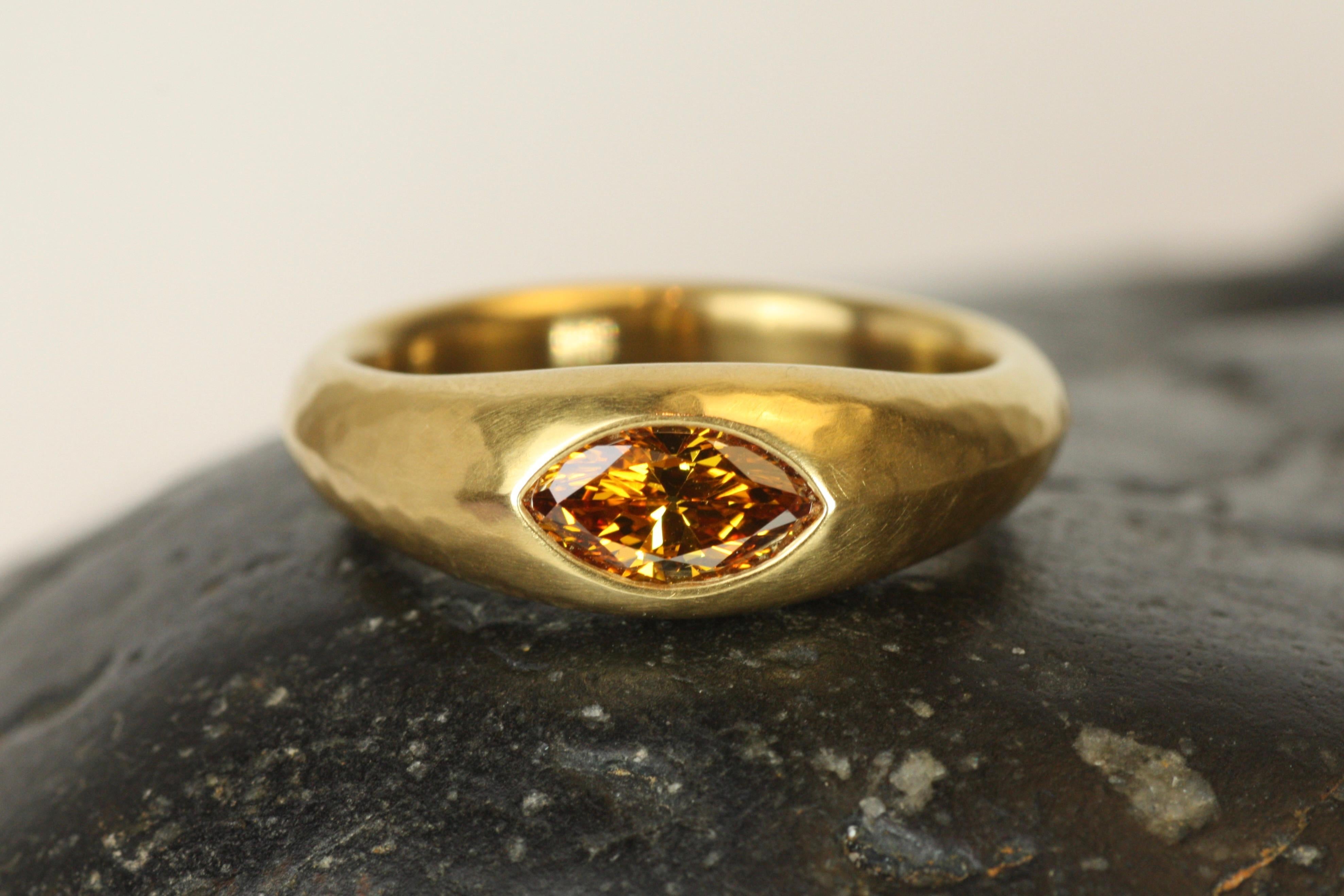 With its striking marquise cut, this 0.56ct orangey brown diamond is truly unique. The diamond, featuring warm tones of yellow too, is set in rich 22K yellow gold, which enhances its earthy hues. The marquise cut elongates the stone and creates a
