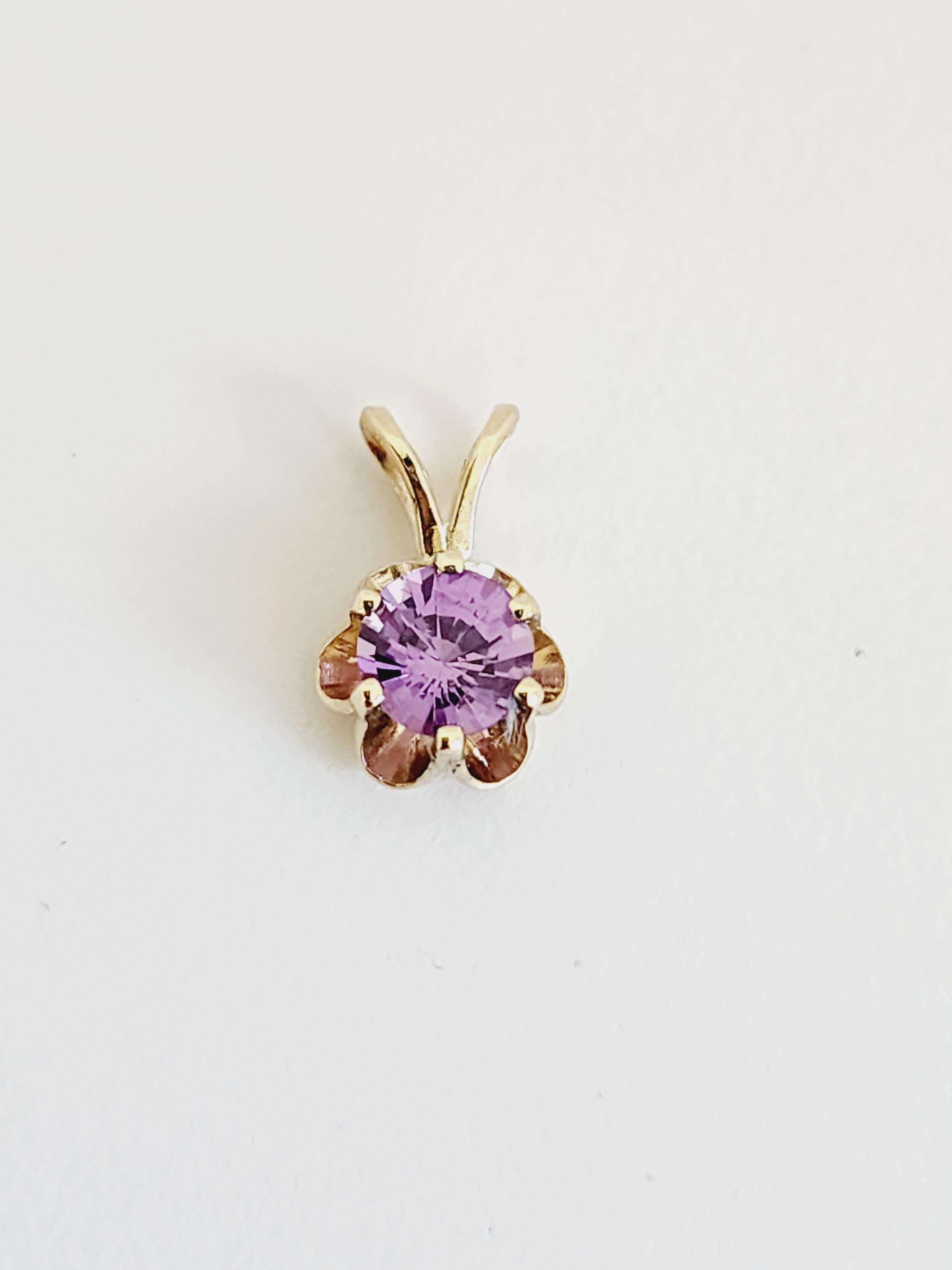 0.56 Carat Purple Sapphire Pendant 14 Karat Yellow Gold. Pendant measures approximately 0.45 inch length and 0.30 inch wide. 

(Pendant Only-Chain sold separately)