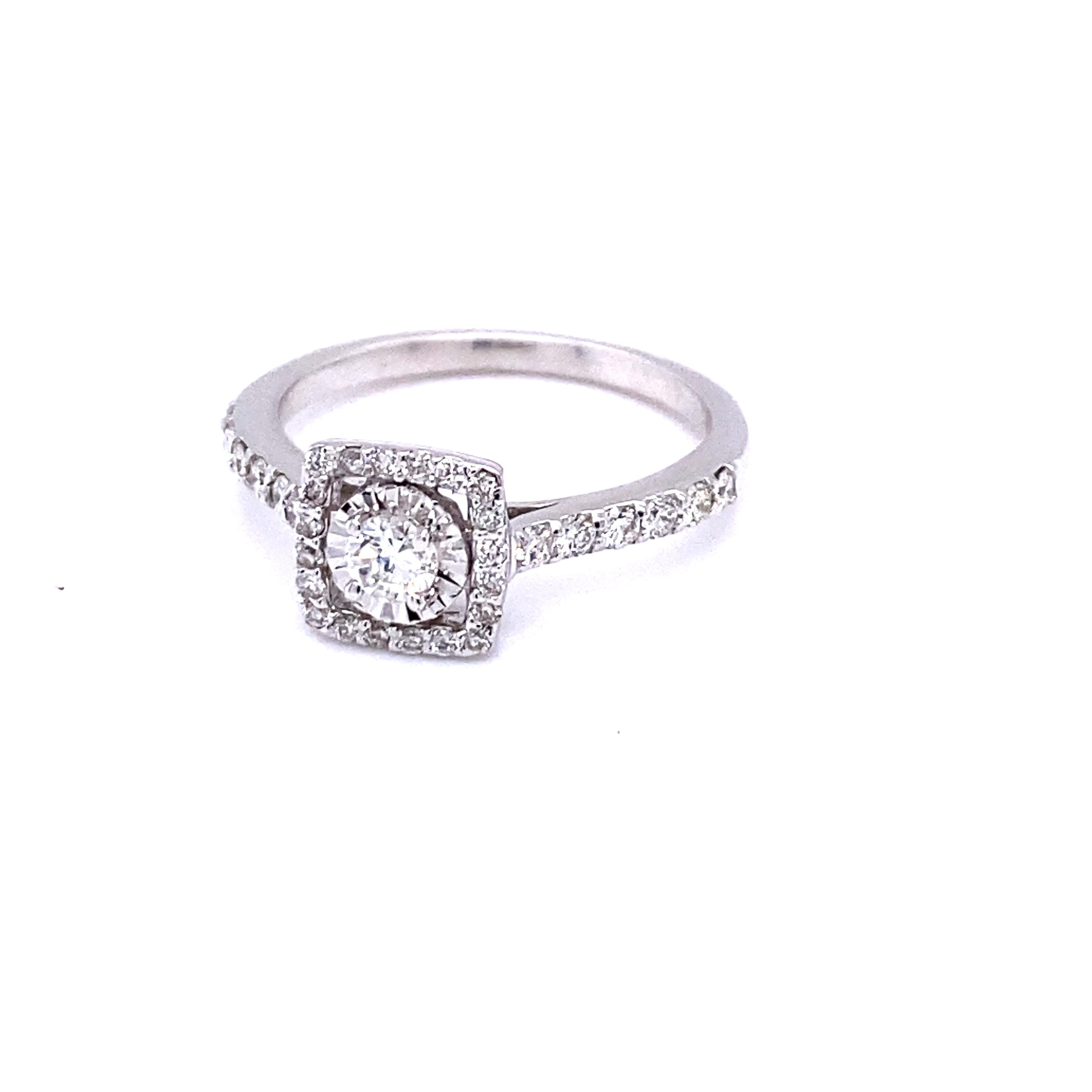 A beautiful Round Cut Diamond Solitaire ring set in a Halo Diamond setting.

The center Round Cut Diamond has a total of 33 Round Cut Diamonds that weigh 0.56 Carats and Clarity and Color of the Diamonds is VS-H.
It is set in 14K White Gold and is