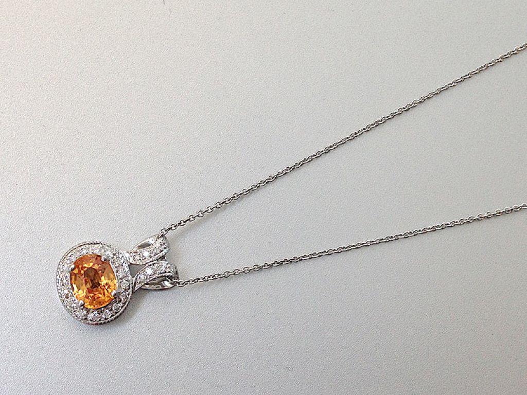 This rare natural Mandarin Garnet pendant captures all the colors of the Fall season perfectly in this sparkling stone. This gem will surely ignite conversations and envy everywhere it goes. The 0.56 carat Garnet and diamonds rest powerfully in an