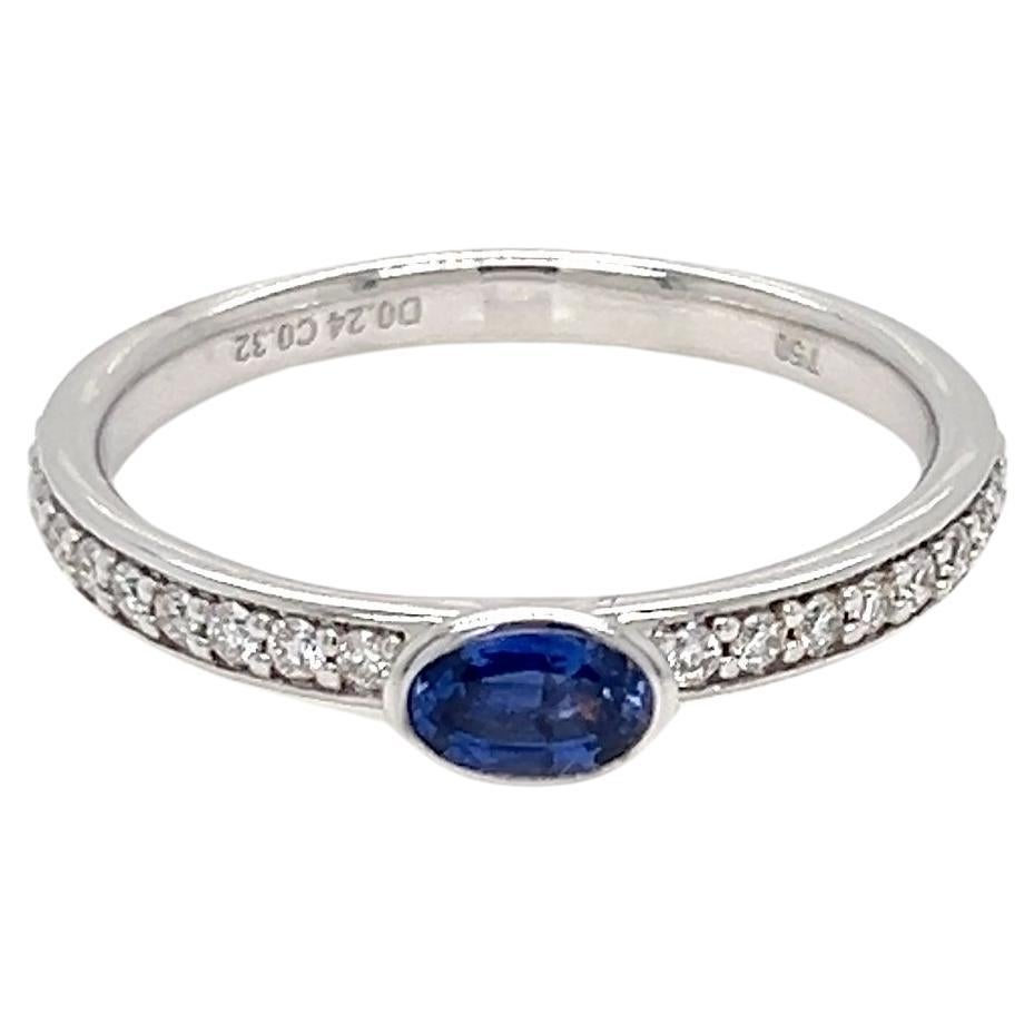 0.56 Carats Oval Sapphire Solitaire Bezel Ring with Diamonds For Sale