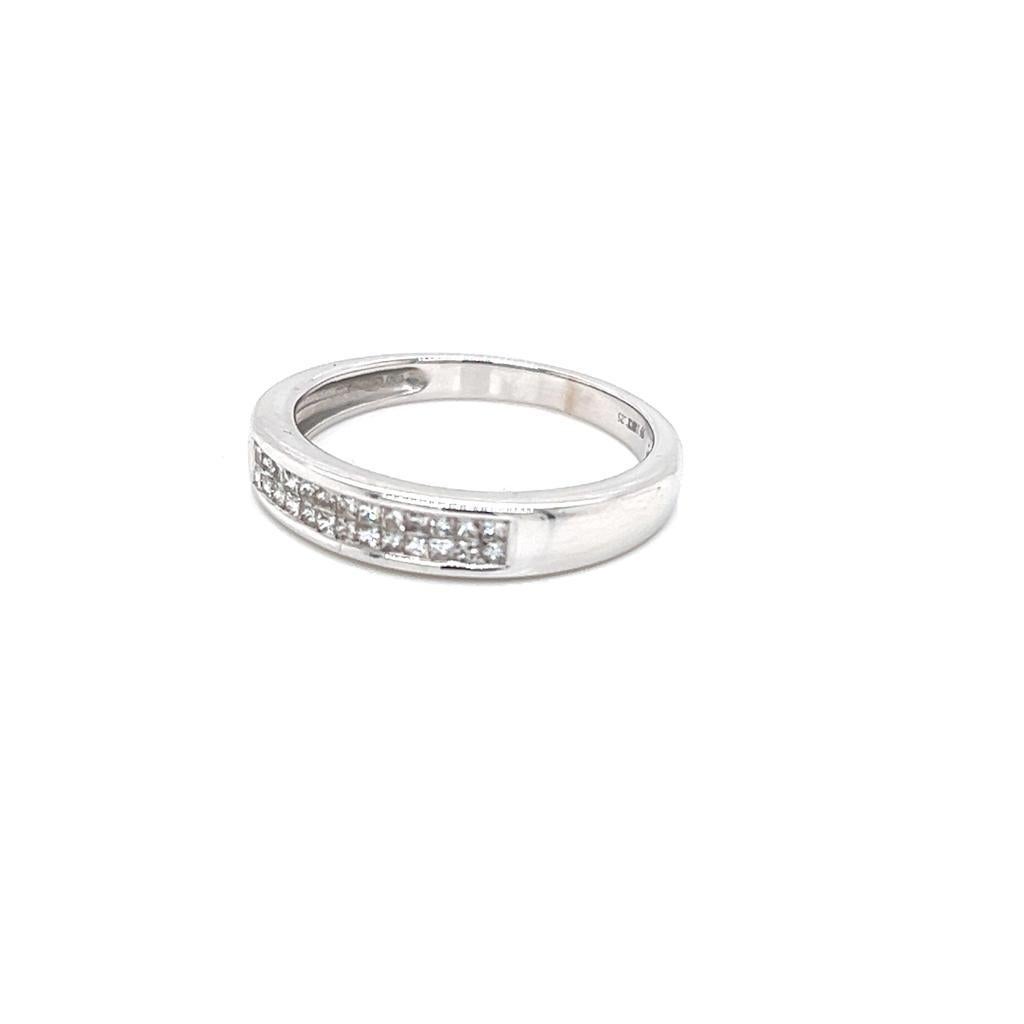 0.56 Carats Princess cut Diamond Ring in 18 Karat White Gold.

This timeless ring features an intricate double row of channel set princess cut Diamonds on an 18K White Gold band. The Diamonds weigh a total of 0.56 carats, and their size and
