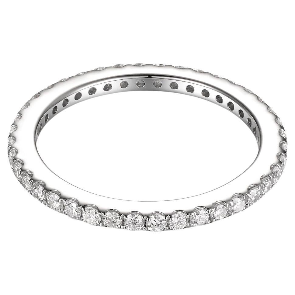 A piece of jewelry is not just an adornment but a reflection of artistry, precision, and passion. This ring, beautifully crafted in 14 karat white gold, is a testament to timeless elegance and classic design. Its shimmering band showcases a series