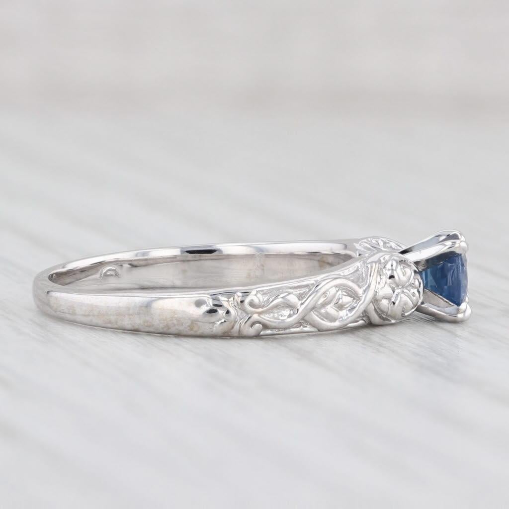 Gemstone Information:
- Natural Sapphire -
Carats - 0.56ct (4.7 mm)
Cut - Round Brilliant
Color - Dark Blue
Treatment - Heated
Please note there are surface reaching inclusions.

Metal: 14k White Gold 
Weight: 3.9 Grams 
Stamps: 14k
Face Height: 4.9