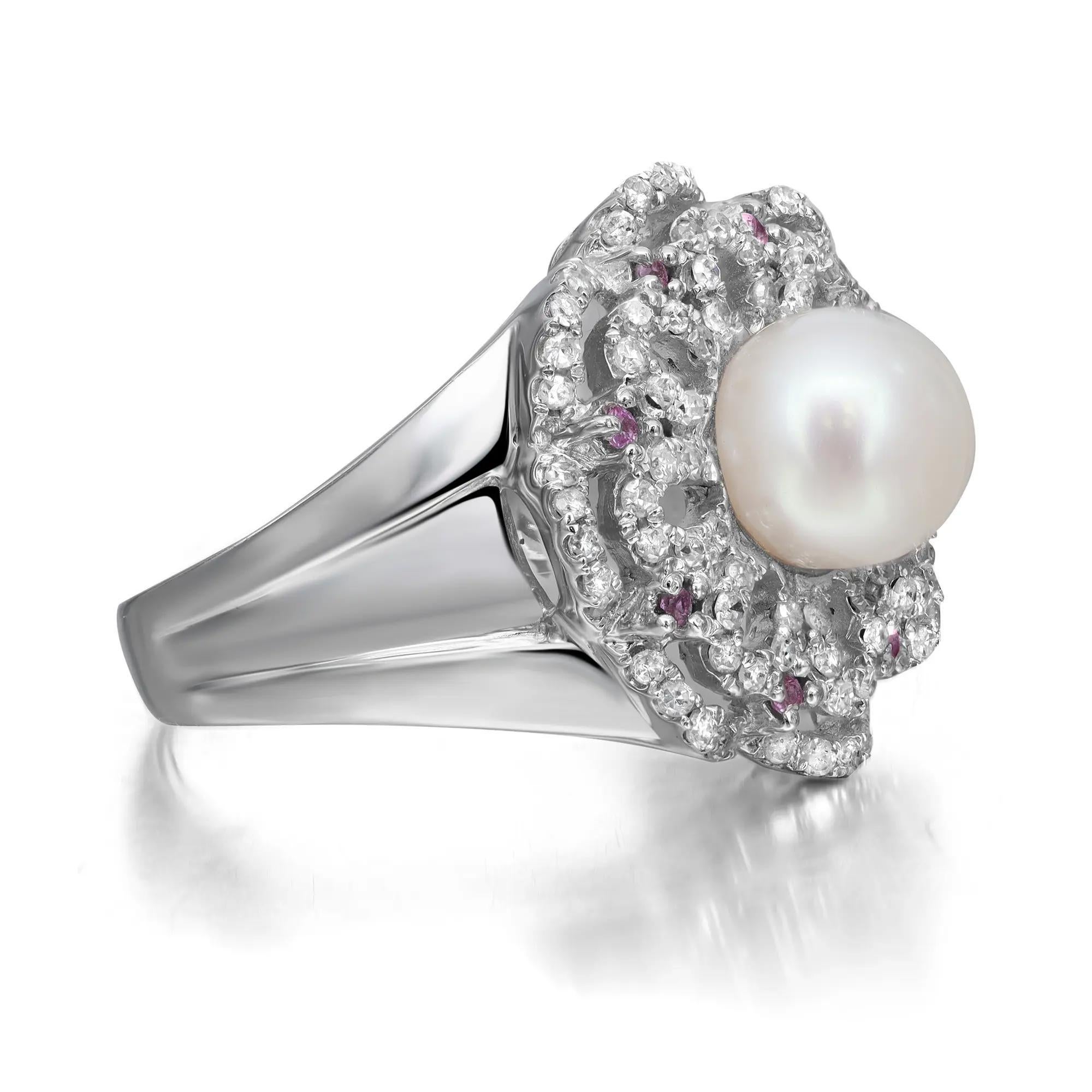 Magnificent ladies cocktail ring. This ring is centered by a beautiful round white pearl. Accentuated with round cut diamonds in a flower pattern weighing 0.56 carat with round cut pink sapphires. Mounted in fine 14k white gold. Handcrafted
