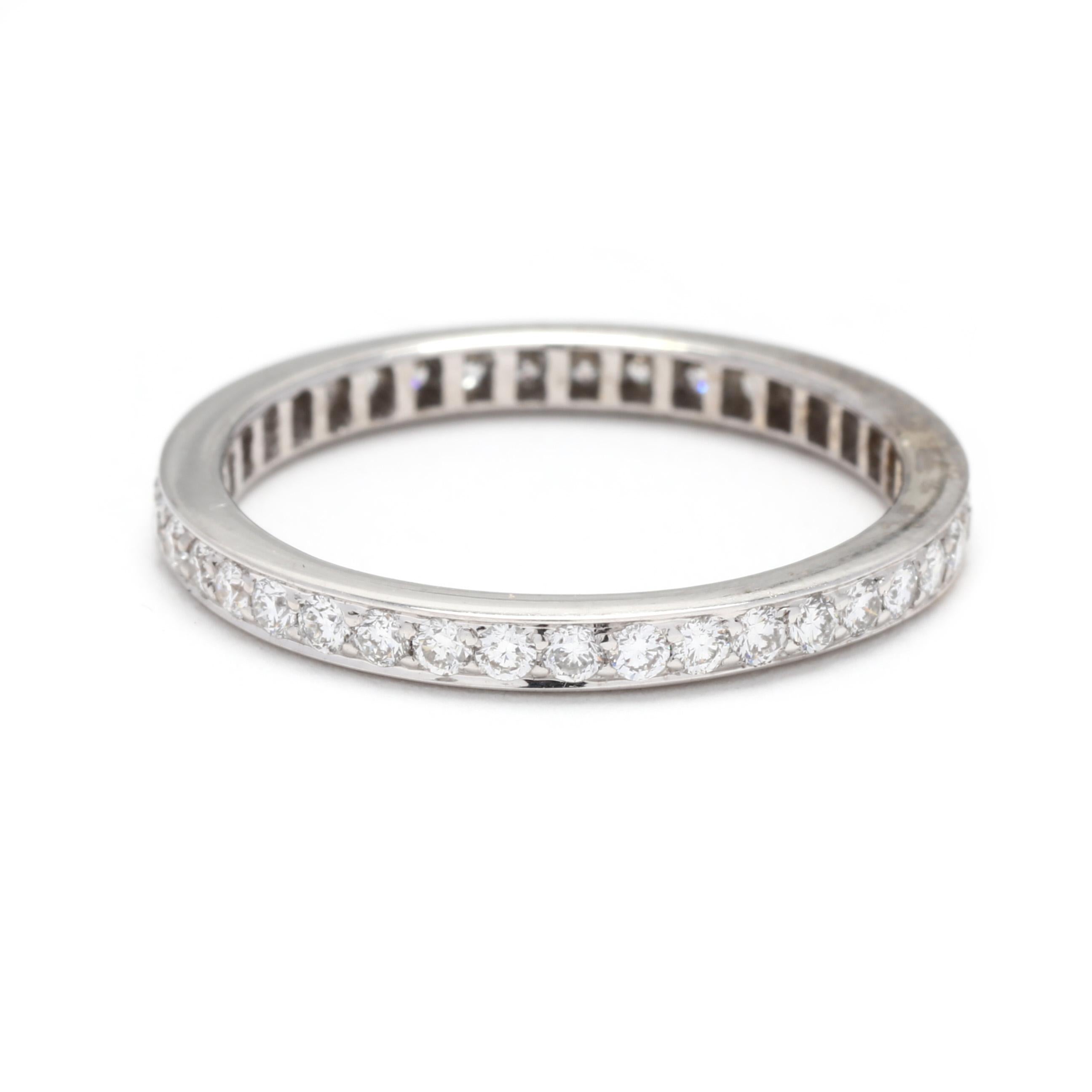 A vintag 18 karat white gold thin diamond eternity wedding band. This stackable band features an eternity design with pavé set round brilliant cut diamonds weighing approximately .56 total carats and a slightly raised edge.

Stones: 
- diamonds
-