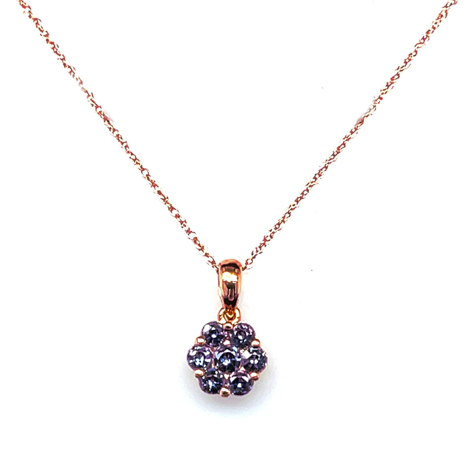 This beautiful cluster pendant features round faceted alexandrites arranged in a lovely floral pattern and set in 14k yellow gold. Alexandrites, the phenomenal color-change variety of chrysoberyl, are extremely rare and are among the most valued