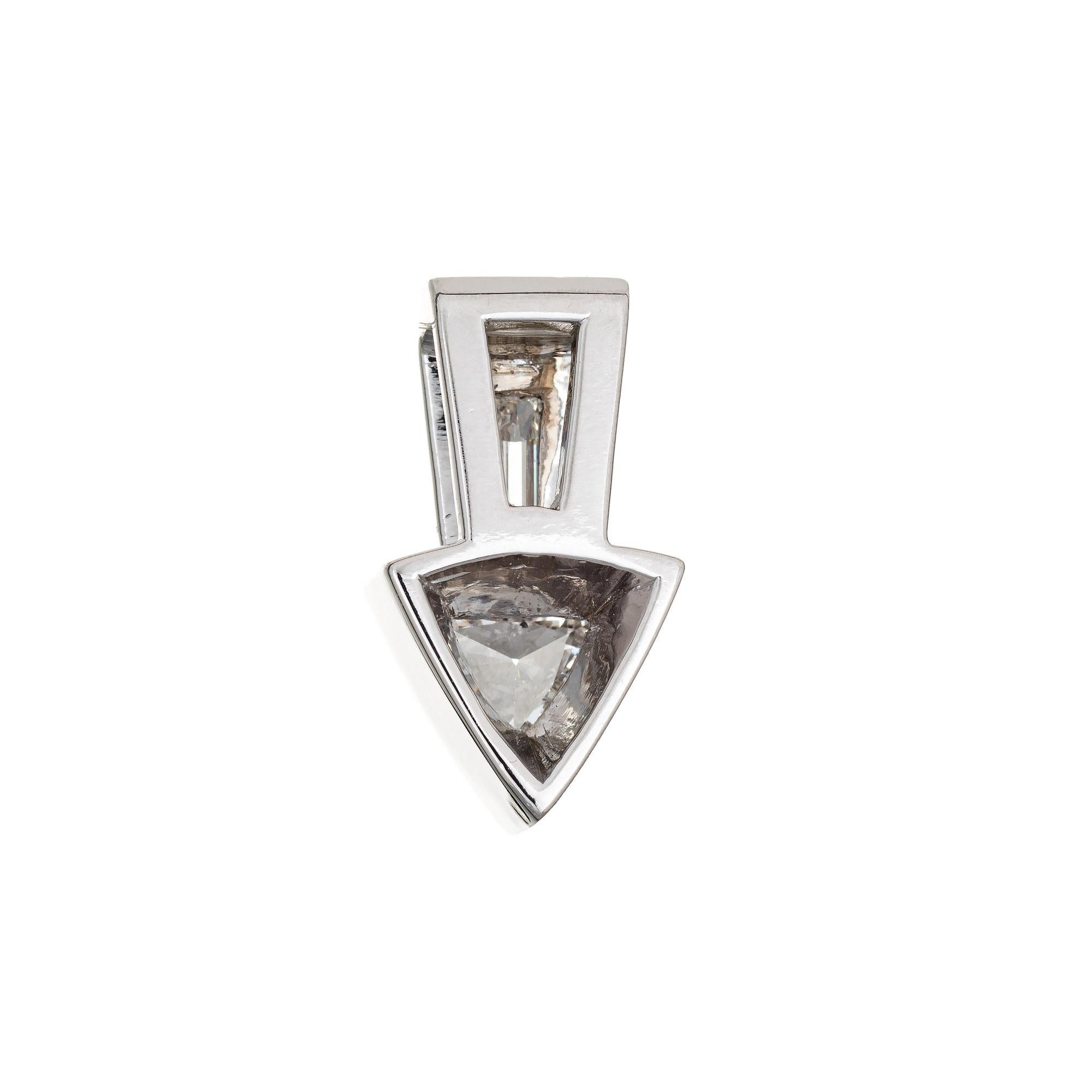 Finely detailed diamond arrow pendant crafted in 14 karat white gold. 

Two diamonds (trillion cut and straight baguette cut) are estimated at 0.33 carats and 0.24 carats. The total diamond weight is estimated at 0.57 carats (estimated at H-I color