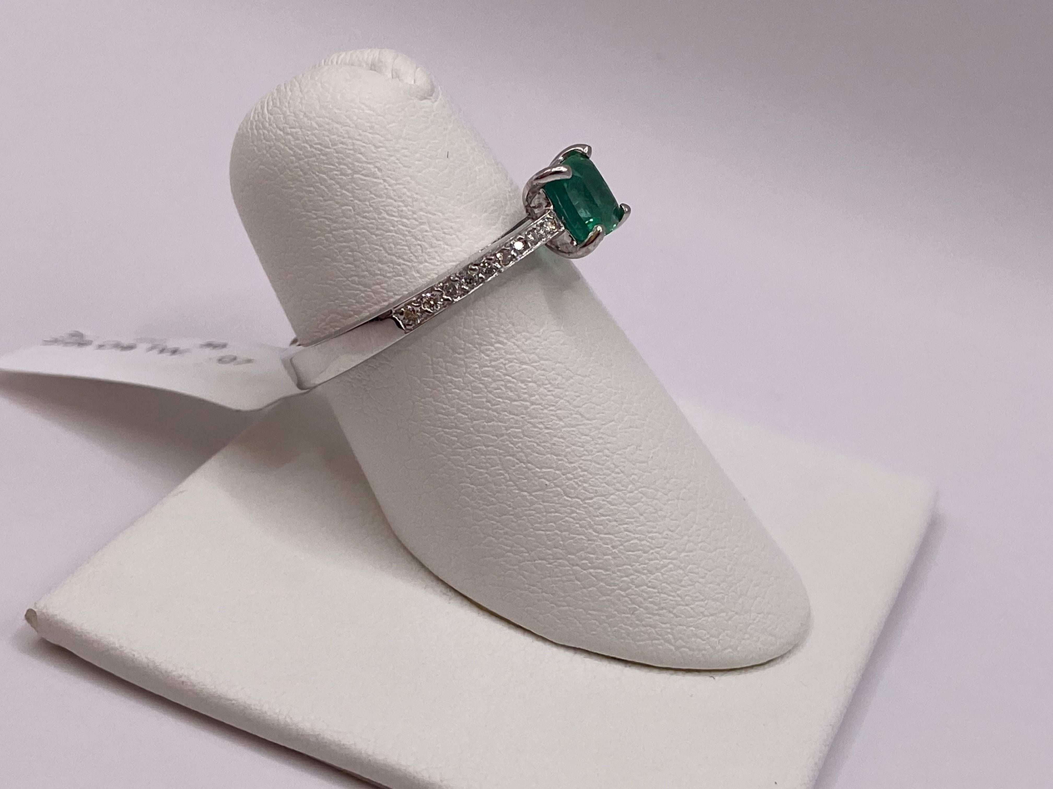 Metal: 14KT White Gold
Finger Size: 6.5
(Ring is size 6.5, but is sizable upon request)

Number of Cushion Emeralds: 1
Carat Weight: 0.50ctw
Stone Size: 5.2 x 5.0mm

Number of Round Diamonds: 18
Carat Weight: 0.07ctw