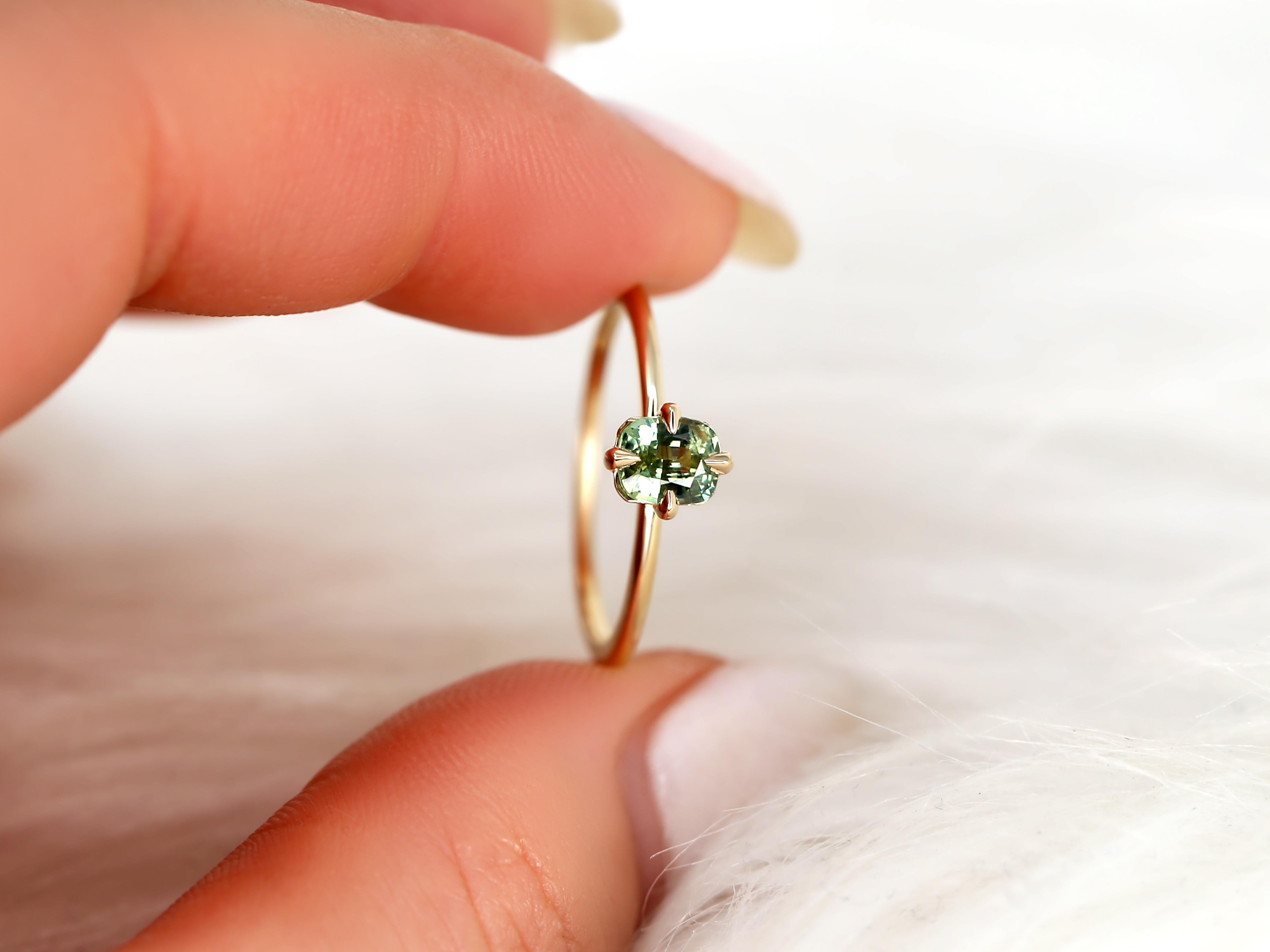 Get ready to shine with this sapphire Rita ring. Its radiant cut and beautiful green tea teal sapphire center stone are perfect for the sophisticated individual who wants to sparkle. Flaunt it on its own or pair it with some delicate diamond bands