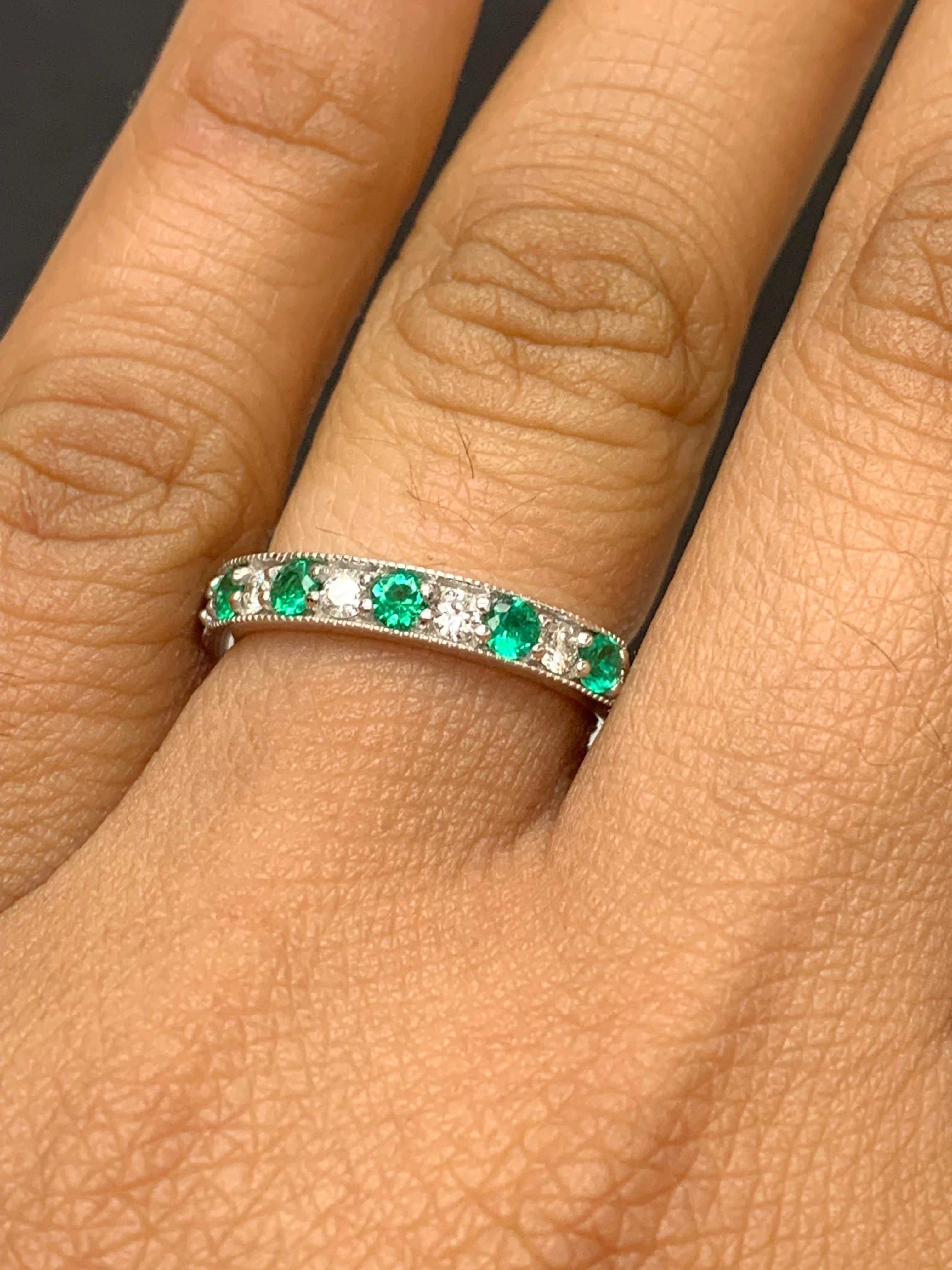 Handcrafted to perfection; showcasing color-rich brilliant-cut emeralds that elegantly alternate brilliant-cut diamonds in an 14k white gold setting. 
The 7 Emeralds weigh 0.58 carats total and 6 diamonds weigh 0.30 carats total.

Size 6.5 US