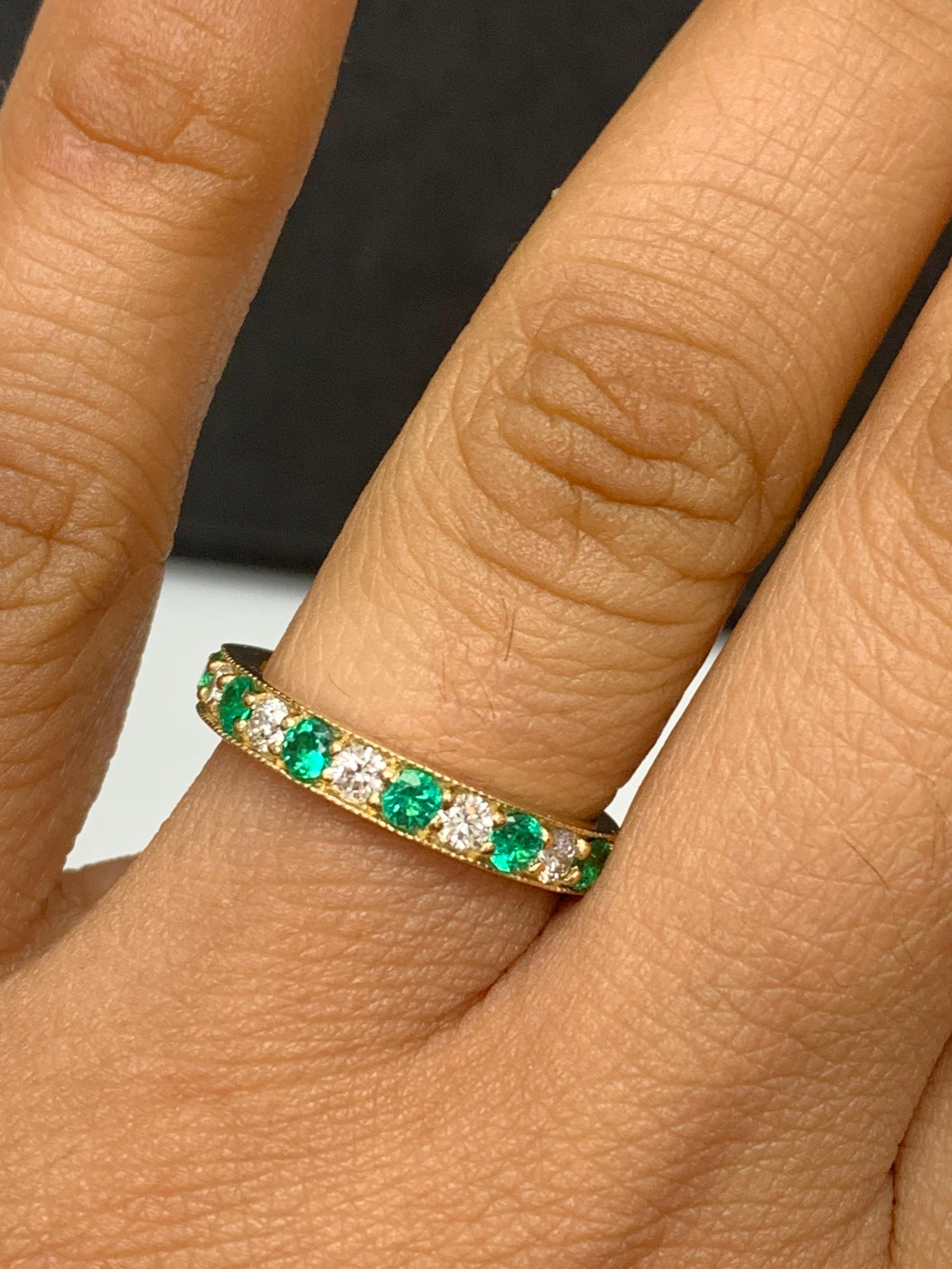 Handcrafted to perfection; showcasing color-rich brilliant-cut emeralds that elegantly alternate brilliant-cut diamonds in an 14k yellow gold setting. 
The 7 Emeralds weigh 0.58 carats total and 6 diamonds weigh 0.30 carats total.

Size 6.5 US